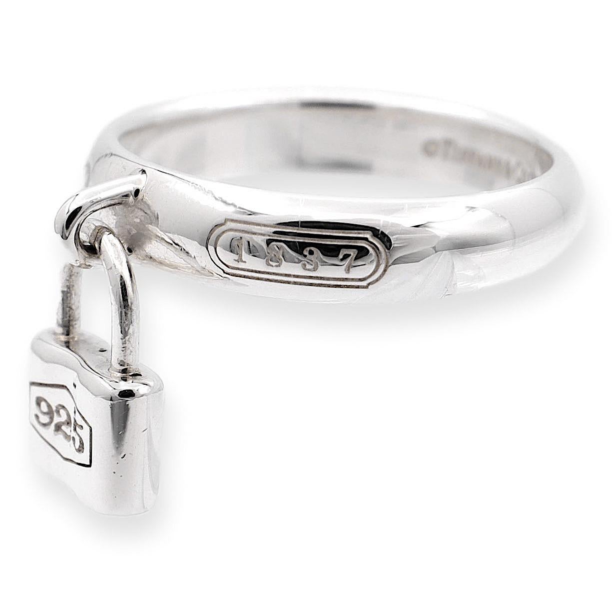 Tiffany & Co. 1837 Collection Sterling Silver Padlock Ring meticulously crafted, this ring showcases a delicate padlock charm, symbolizing enduring love and commitment. Adorned with the iconic 1837 logo and full metal content hallmarks. 

Ring
