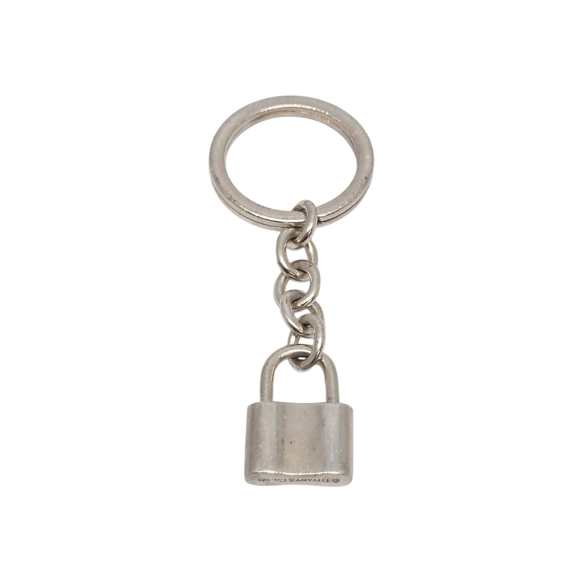 Sterling silver 1837 padlock keychain/key ring by Tiffany & Co.

This Tiffany & Co key ring features their iconic 1837 padlock design depicting the year Tiffany was founded. Tiffany & Co box and pouch are not included.

Measures approx 2 1/2
