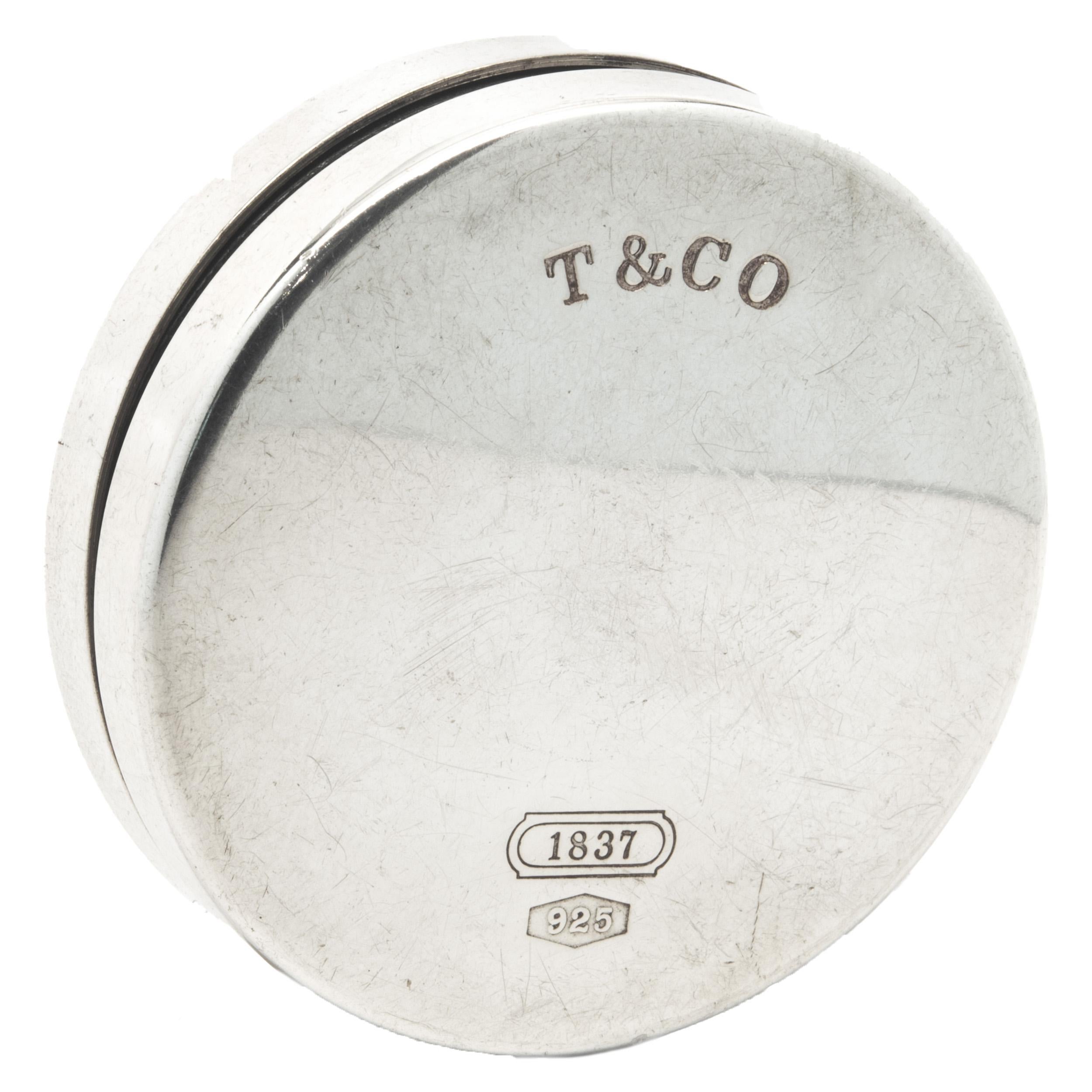 Designer: Tiffany & Co. 
Material: sterling silver
Dimensions: tape measure measures 1.75-inches wide
Weight: 65.17 grams