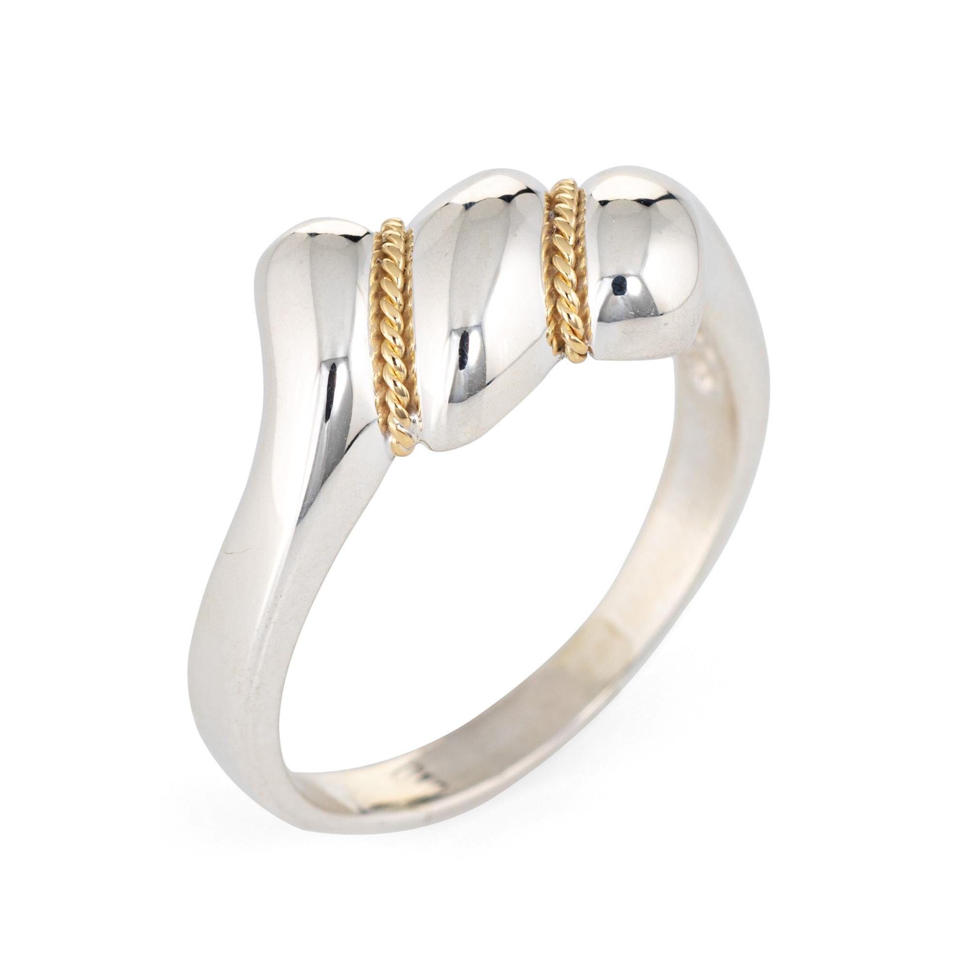 Finely detailed estate Tiffany & Co crafted in sterling silver & 18 karat yellow gold. 

The stylish ring features three low rise 'domes' with 18k yellow gold rope detail. The low rise ring (3.5mm - 0.13 inches) sits comfortably on the finger. 