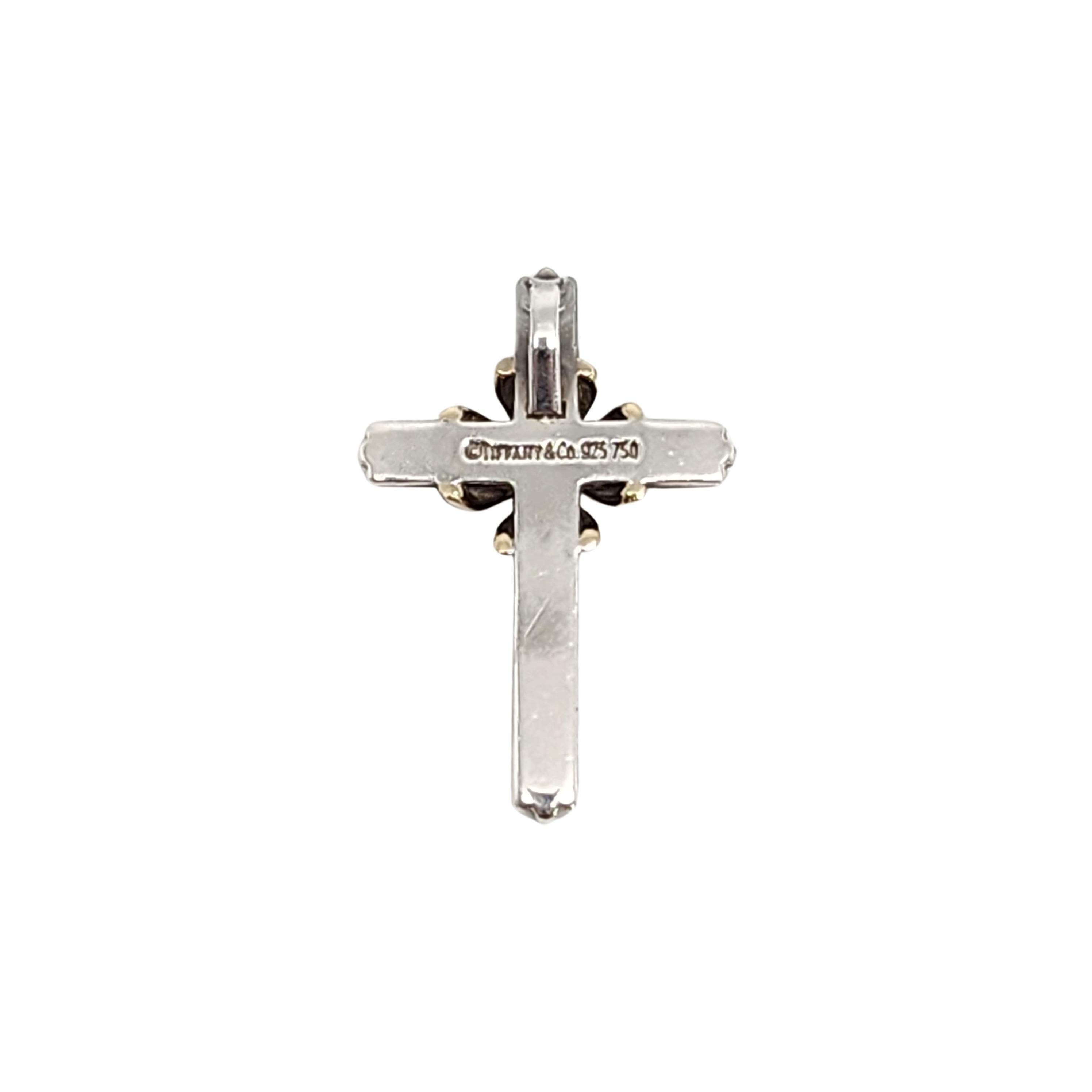 Tiffany & Co sterling silver and 18K yellow gold cross pendant.

Authentic Tiffany pendant in a classic and timeless design, featuring sterling silver cross with 18K yellow gold accent at its center. Does not include Tiffany box and pouch.

Measures