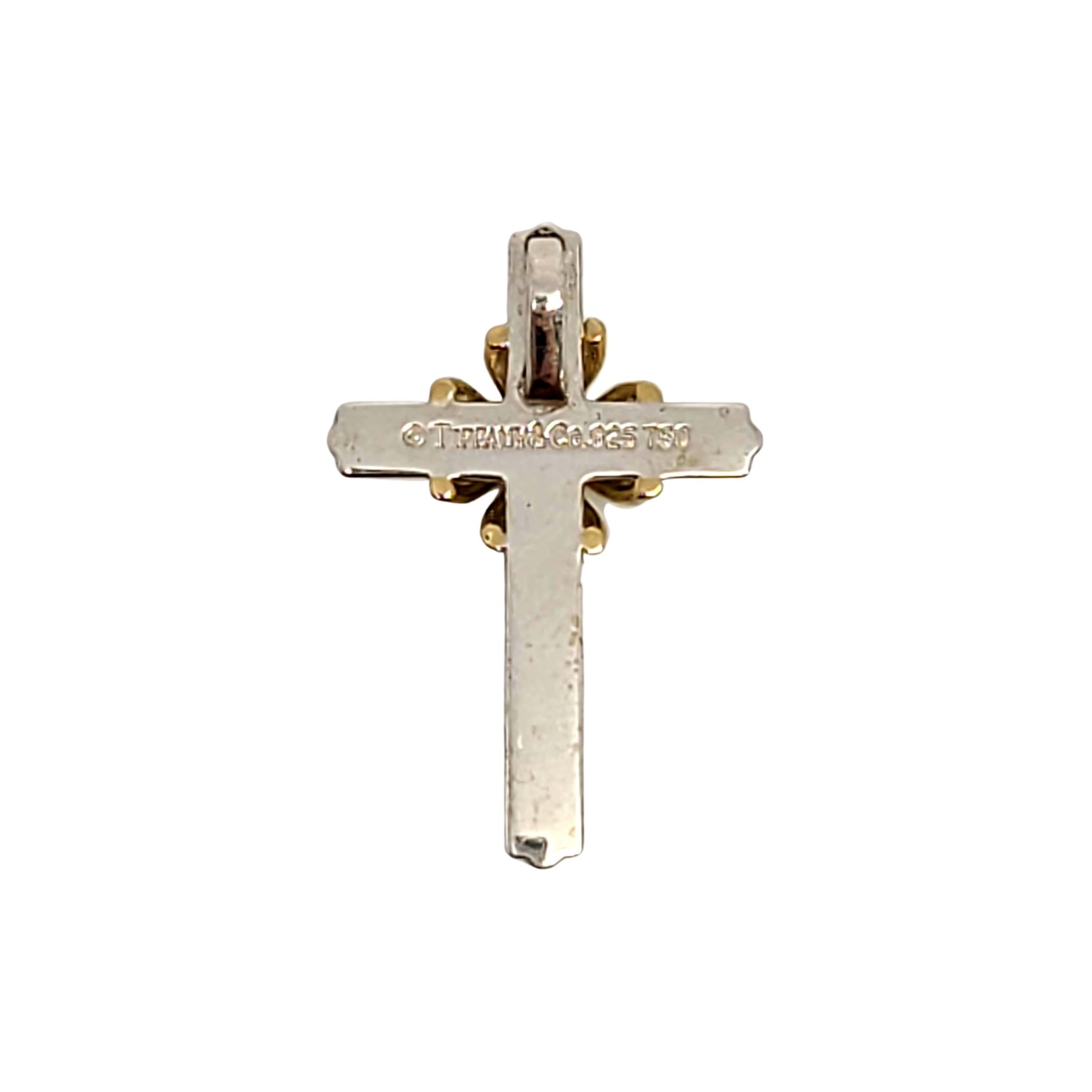 Tiffany & Co sterling silver and 18K yellow gold cross pendant.

Authentic Tiffany pendant in a classic and timeless design, featuring sterling silver cross with 18K yellow gold accent at its center. Tiffany box and pouch not included.

Measures