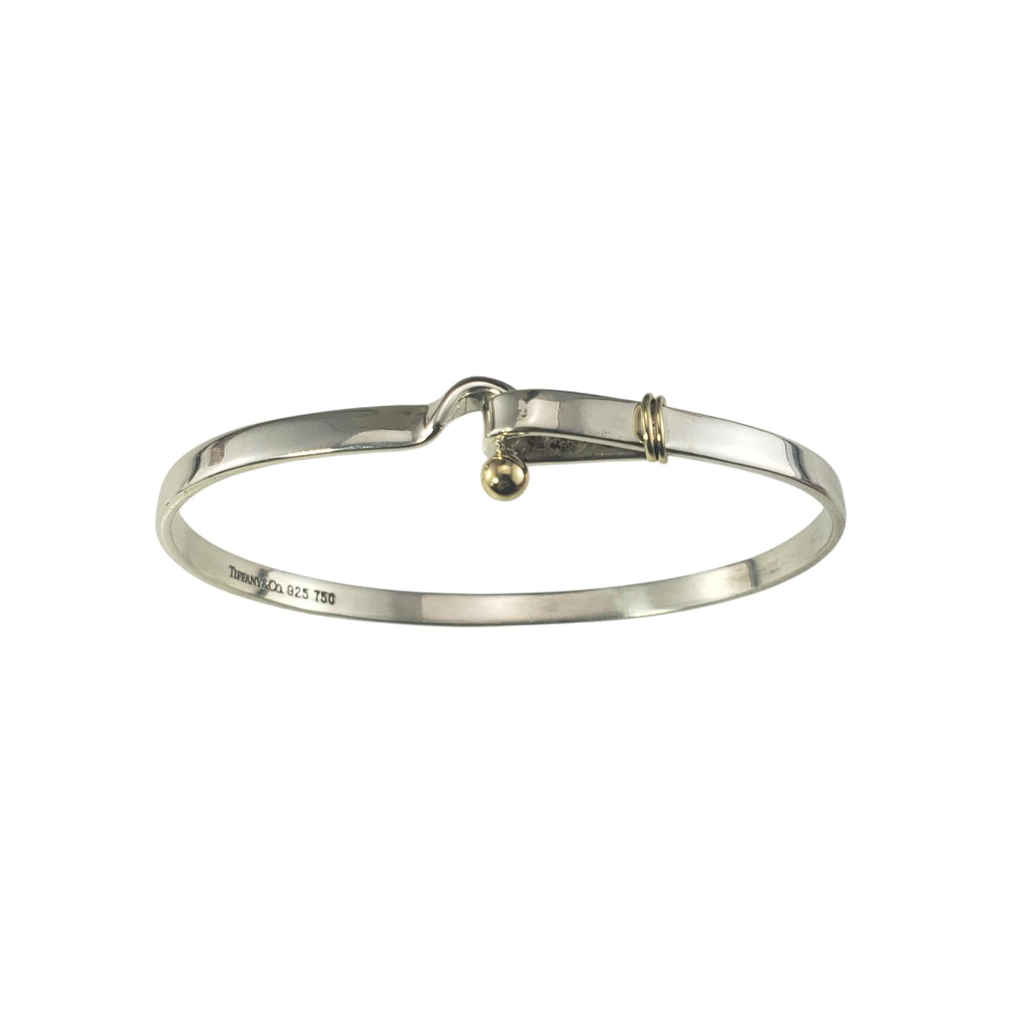 Tiffany & Co. Sterling Silver and 18K Yellow Gold Hook & Eye Bangle Bracelet

This classic Hook & Eye bracelet by Tiffany & Co. is crafted in elegant sterling silver and 18K yellow gold. Width: 4 mm.

Size: 7 inches

Weight: 8.2 dwt/ 12.7