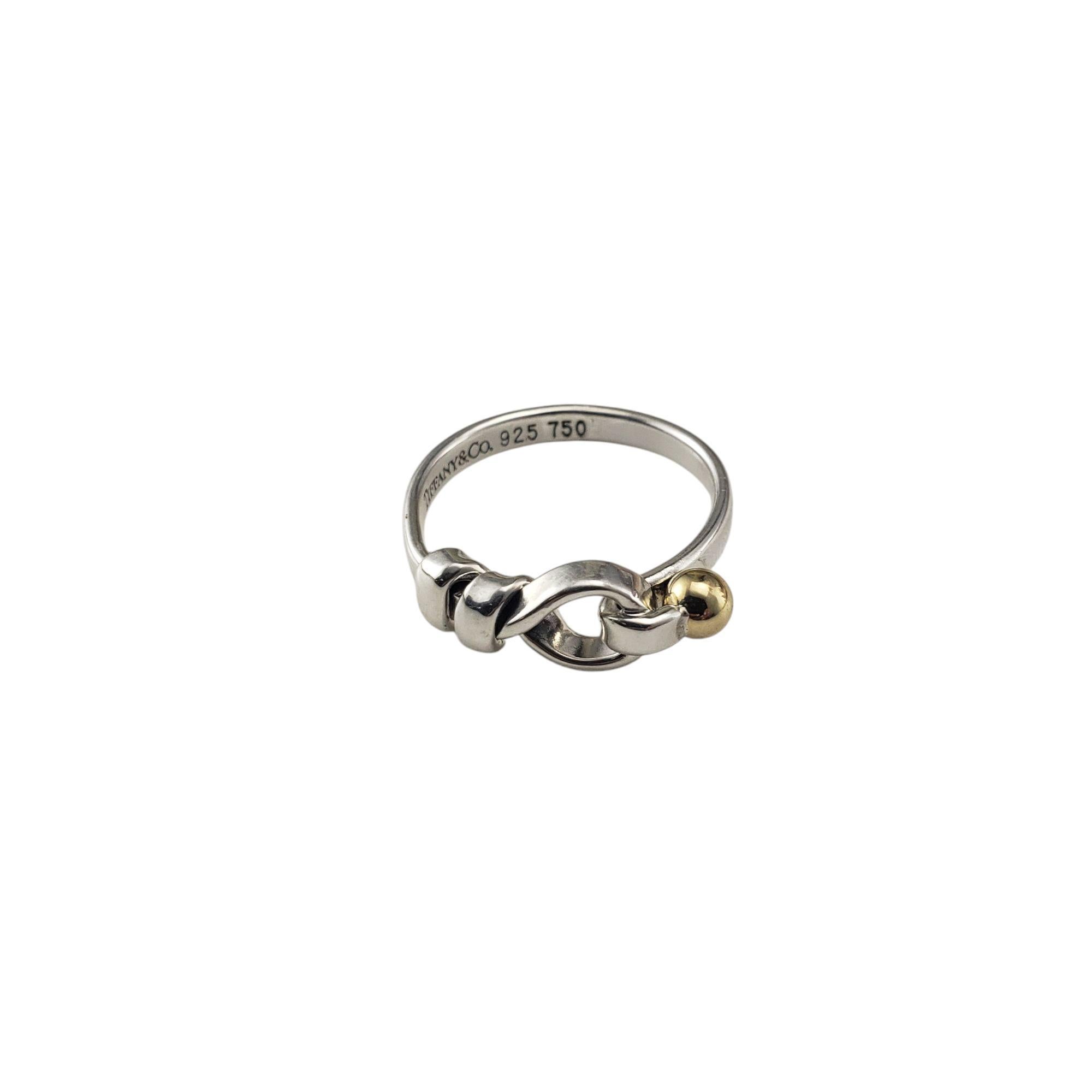 Tiffany & Co. Sterling Silver & 18K Yellow Gold Hook & Eye Ring Size 6.5

This distinctive ring showcases Tiffany's commitment to elegant and functional style. Crafted from high-quality sterling silver, it features a unique hook and eye design,