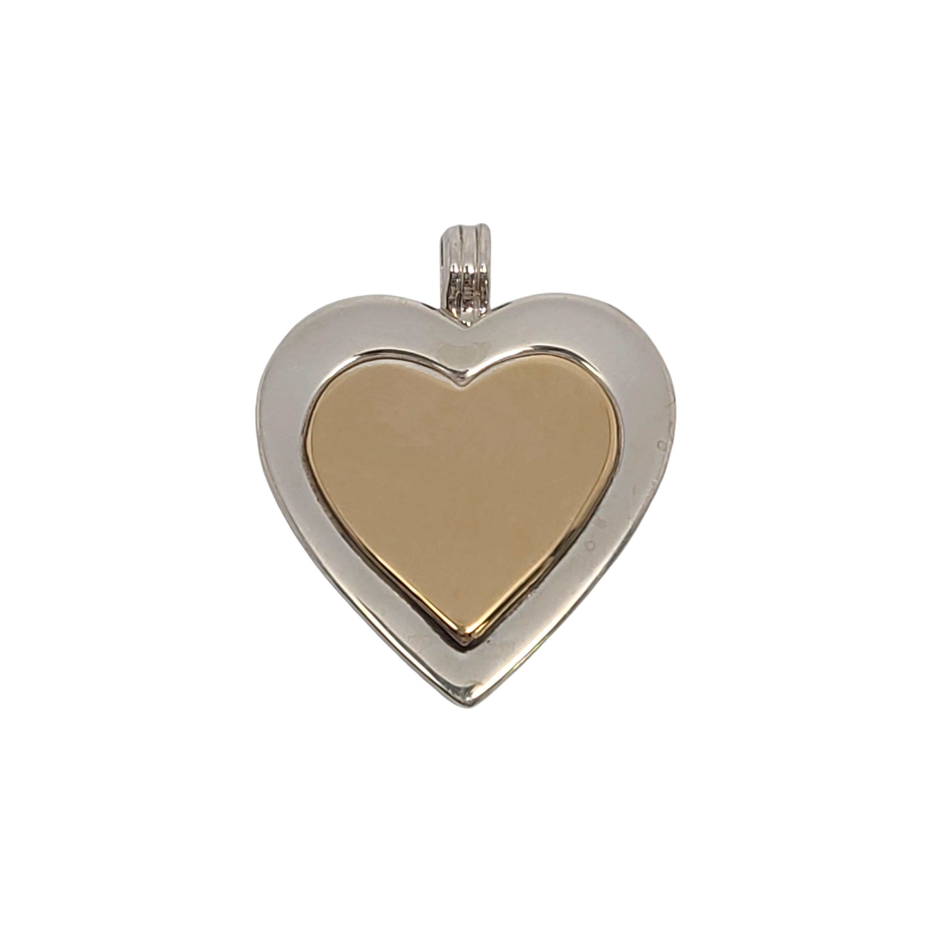Tiffany & Co sterling silver and gold plated heart pendant.

Authentic Tiffany sterling silver heart pendant with 18K yellow gold over sterling silver inner heart. Includes Tiffany & Co pouch.

Measures approx 1 1/4