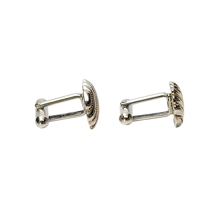 Tiffany & Co sterling silver and 18K yellow gold rope cufflinks.

Authentic Tiffany cufflinks in a classic and timeless design, featuring 18K yellow gold rope accents. Tiffany box and pouch not included.

Measures approx 3/4