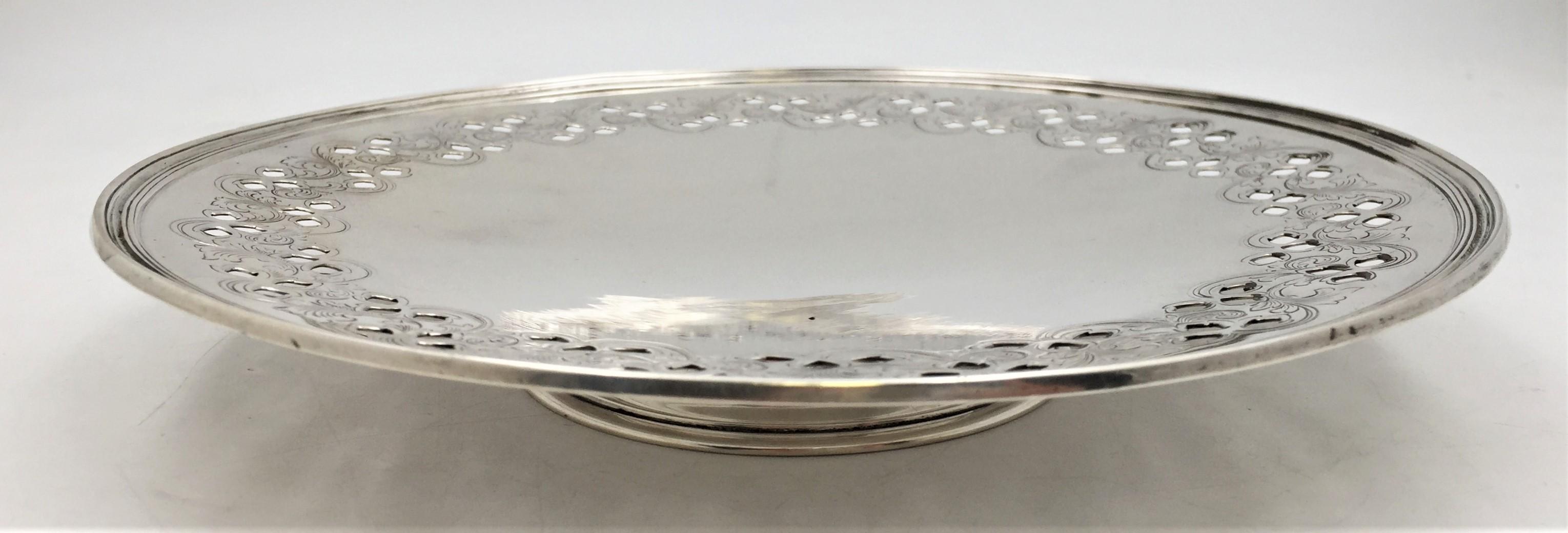 Tiffany & Co. sterling silver footed platter or compote in exquisite Art Nouveau style with pierced and engraved leaf motifs in stylized manner and in pattern number 16971A from 1907. It measures 10 1/2'' in diameter by 1 2/3'' in height, weighs