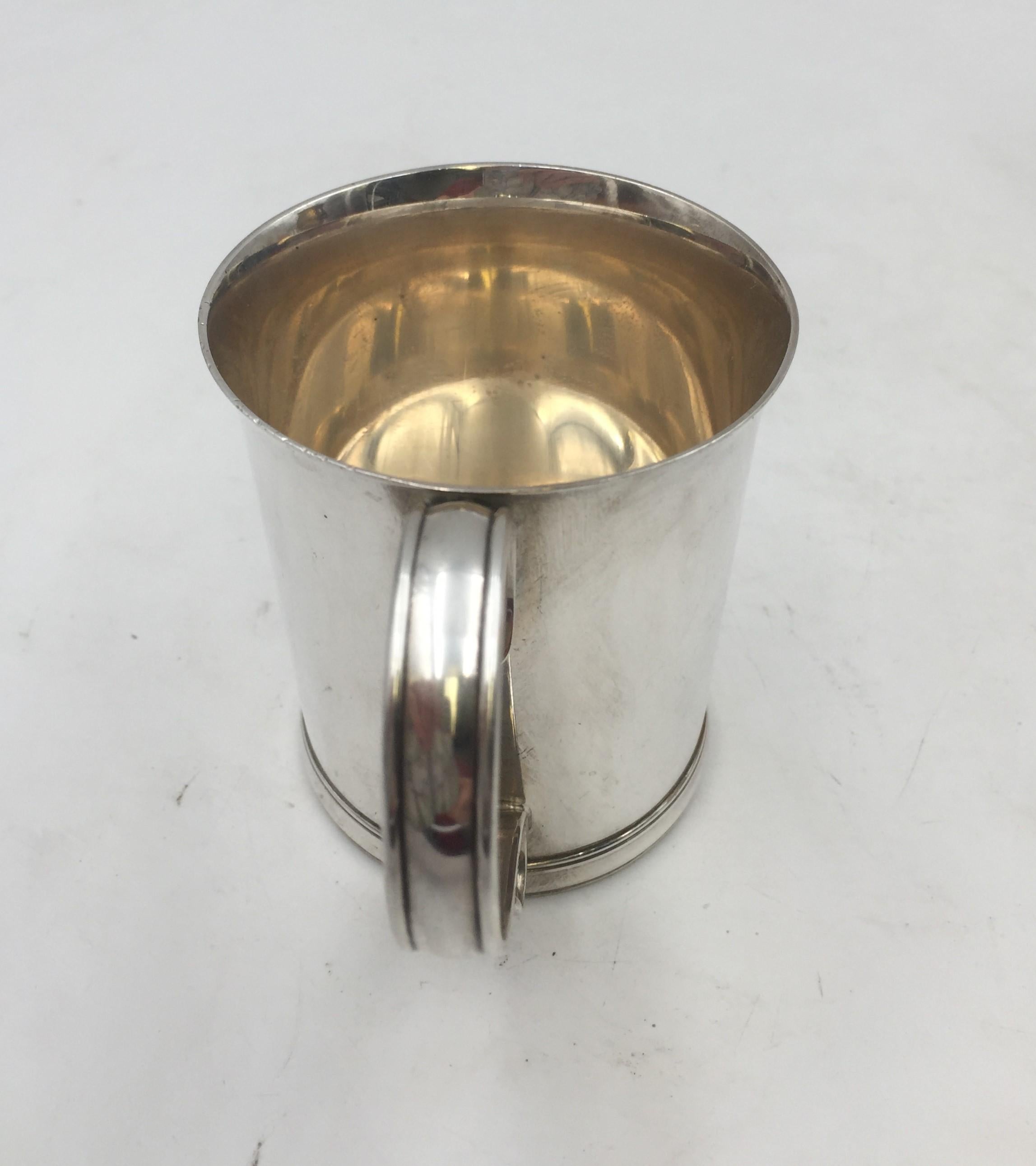 Tiffany & Co. sterling silver Christening cup / child mug in pattern 19184 from 1916 in simple, elegant design, measuring 3 1/4'' in height and 4 1/4'' from handle to cup, weighing 6.3 ozt, and bearing hallmarks as shown.

Founded in 1837 by