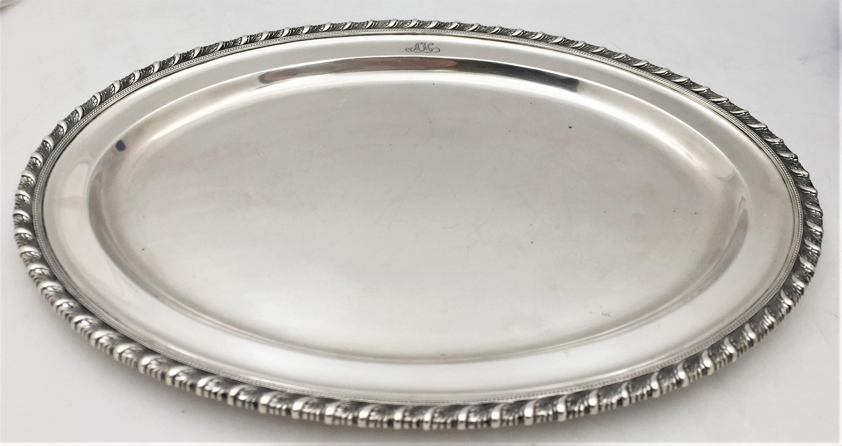 Tiffany & Co. sterling silver tray or platter in pattern number 19961 from 1921, with a rope border showing stylized natural motifs. It measures 16 1/8'' in length by 11 1/2'' in width by 7/8'' in height, weighs 45.4 troy ounces, and bears hallmarks