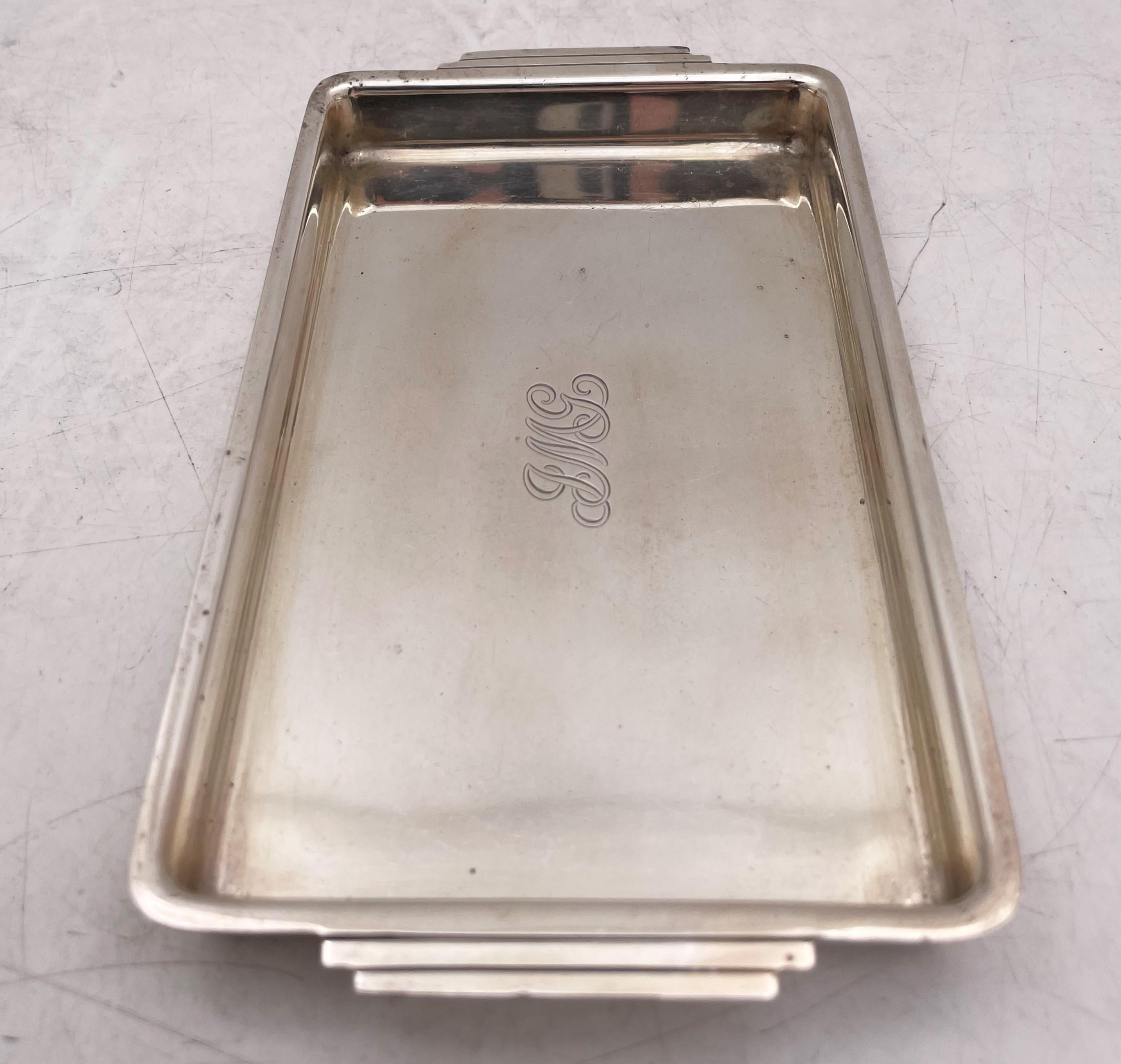 Tiffany & Co. sterling silver trinket tray or dish in Art Deco style and in pattern number 22326 from 1936 with elegant handles. It measures 6 1/2'' in length from handle to handle by 3 5/8'' in width by 1/2'' in height, weighs 5.5 troy ounces, and