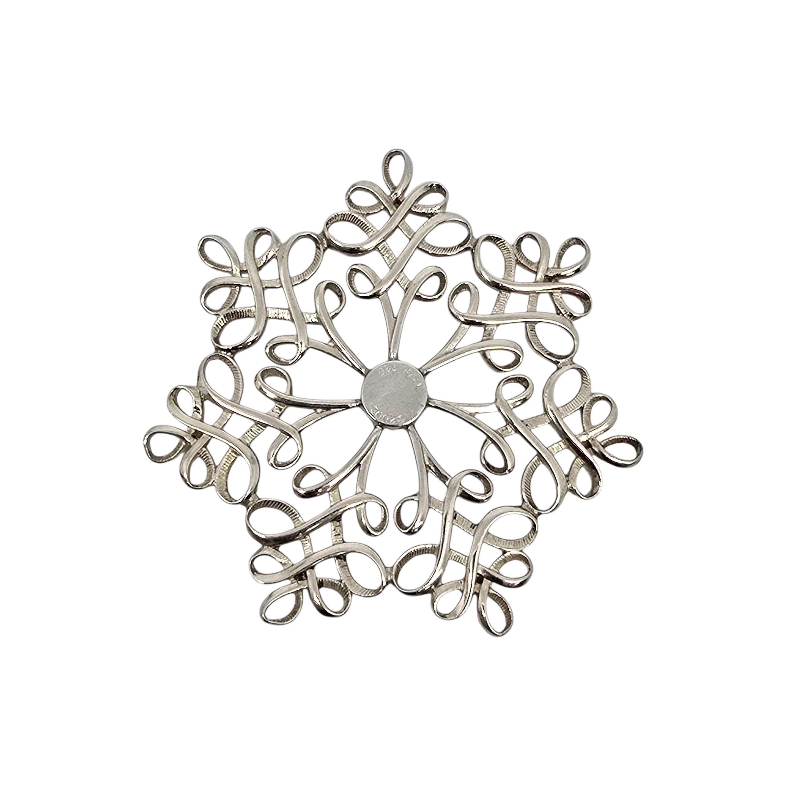 Tiffany & Co sterling silver Snowflake Ornament, circa 2002.

Beautifully ornate snowflake made of sterling silver. Tiffany & Co box and pouch are not included.

Weighs approx 36.0g, 23.2dwt

Measures approx 2 3/4