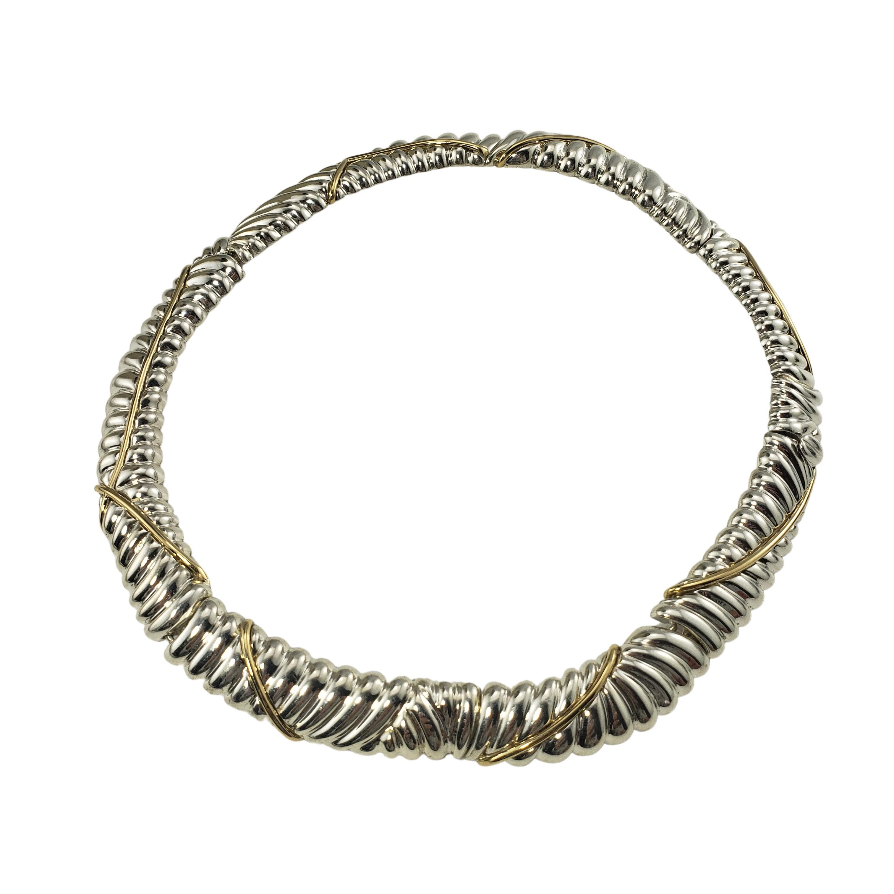 Tiffany & Co. Sterling Silver and 18 Karat Yellow Gold Choker Necklace-

This stunning necklace is crafted in beautifully detailed sterling silver and accented with 18K yellow gold.  Width:  15 mm

Size:  17 inches

Weight:    60.9 dwt. /   94.8