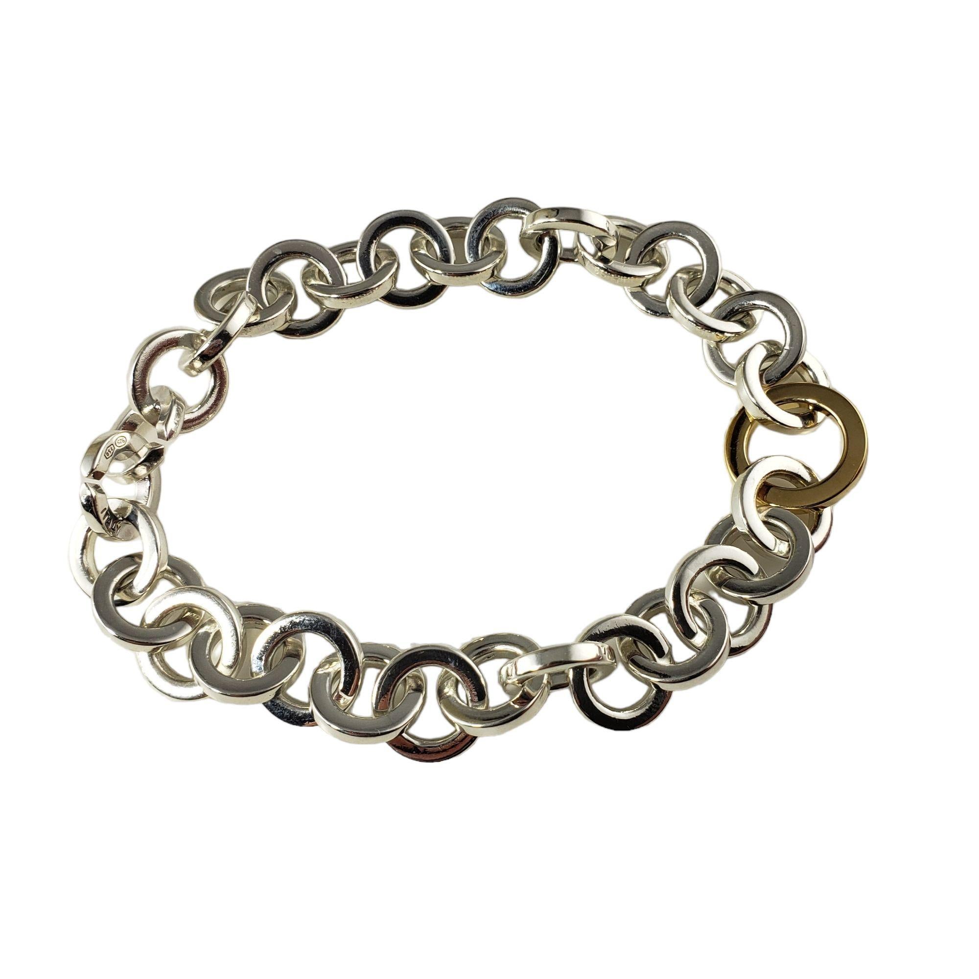Vintage Tiffany & Co. Sterling Silver and 18 Karat Yellow Gold Link Bracelet-

This lovely circle link bracelet is crafted in beautifully detailed sterling silver and 18K yellow gold. Width: 15 mm.

Size: 8 inches

Weight: 40.1 gr./ 25.7