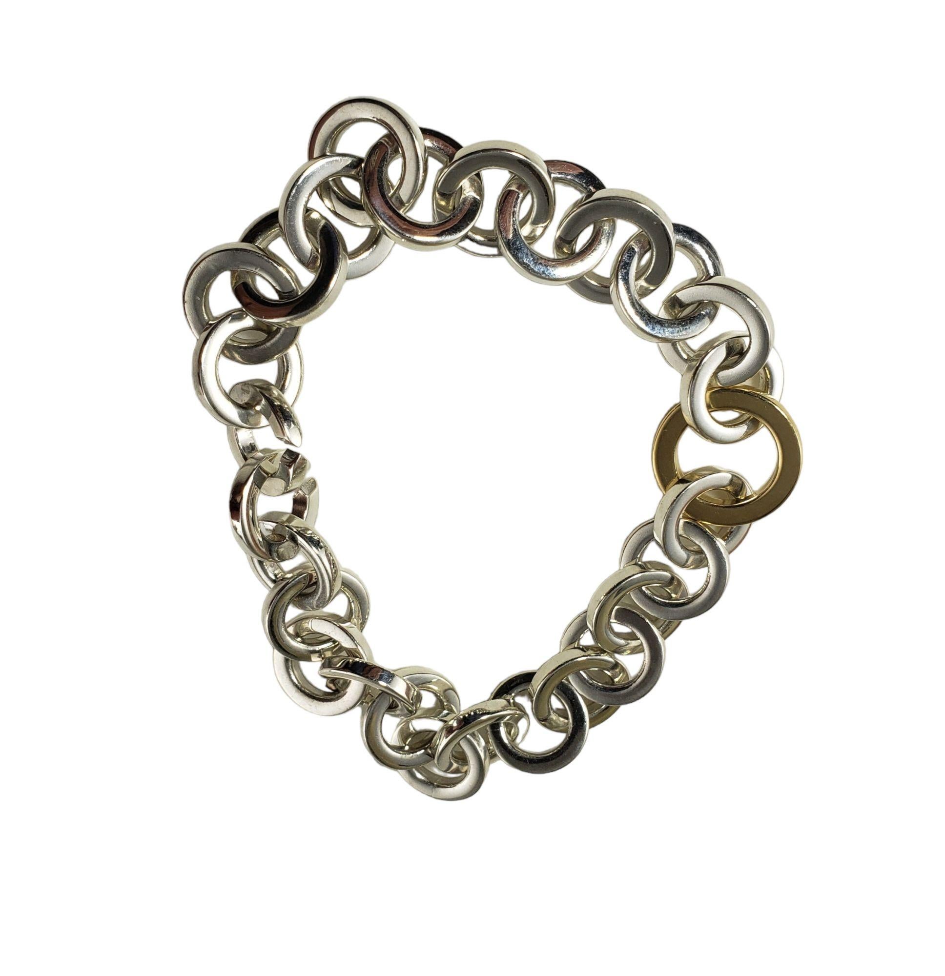 Vintage Tiffany & Co. Sterling Silver and 18 Karat Yellow Gold Open Circle Link Bracelet-

This lovely link bracelet by Tiffany & Co. is crafted in beautifully detailed sterling silver and 18K yellow gold. Width: 15 mm.

* Matching necklace: