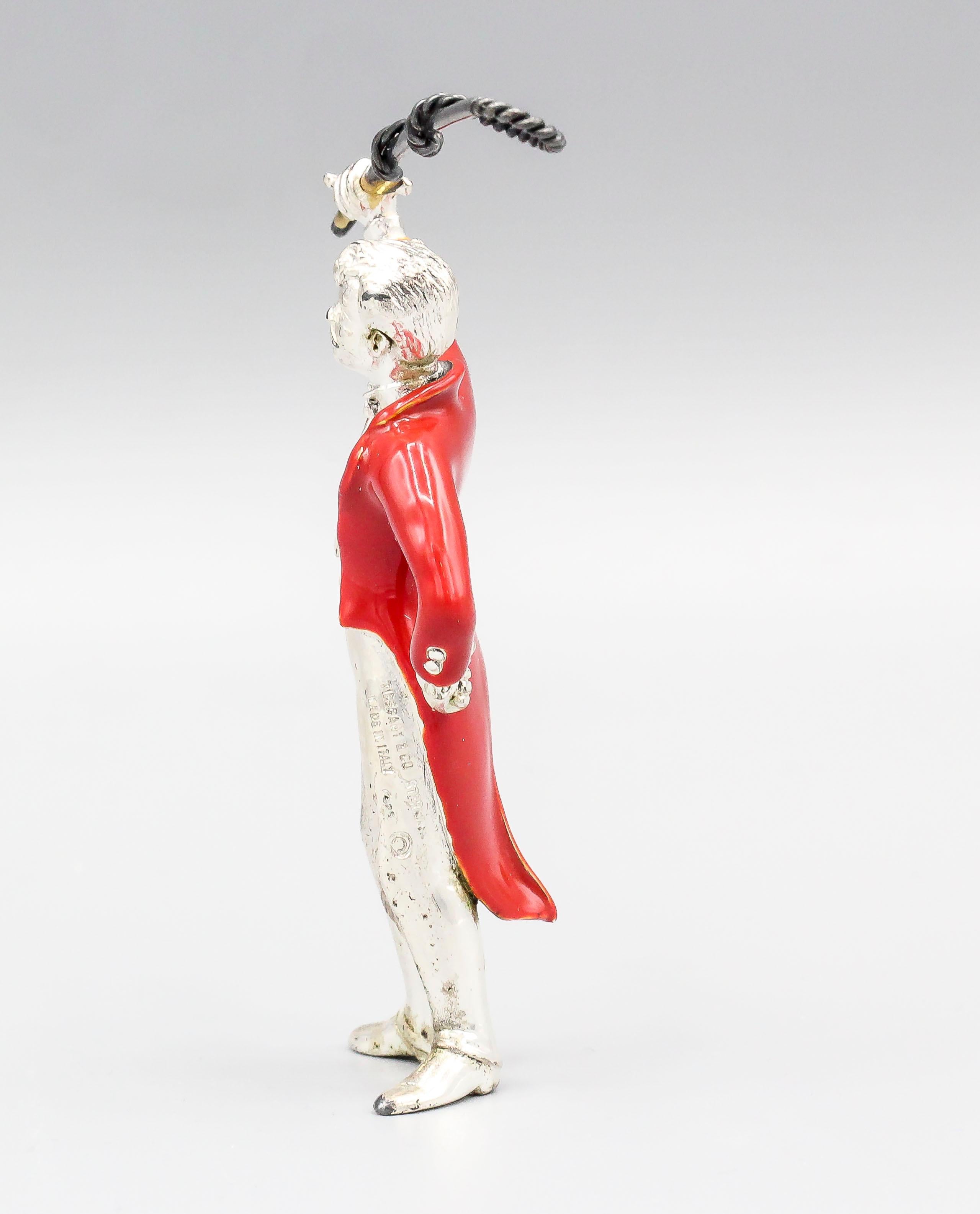 Fine sterling silver and red enamel circus figurine set by Tiffany & Co., circa 1990s, of Italian origin. The figure is in the likeness of an animal trainer/tamer with whip.  


Hallmarks: Tiffany & Co., Sterling, 925, Made in Italy.