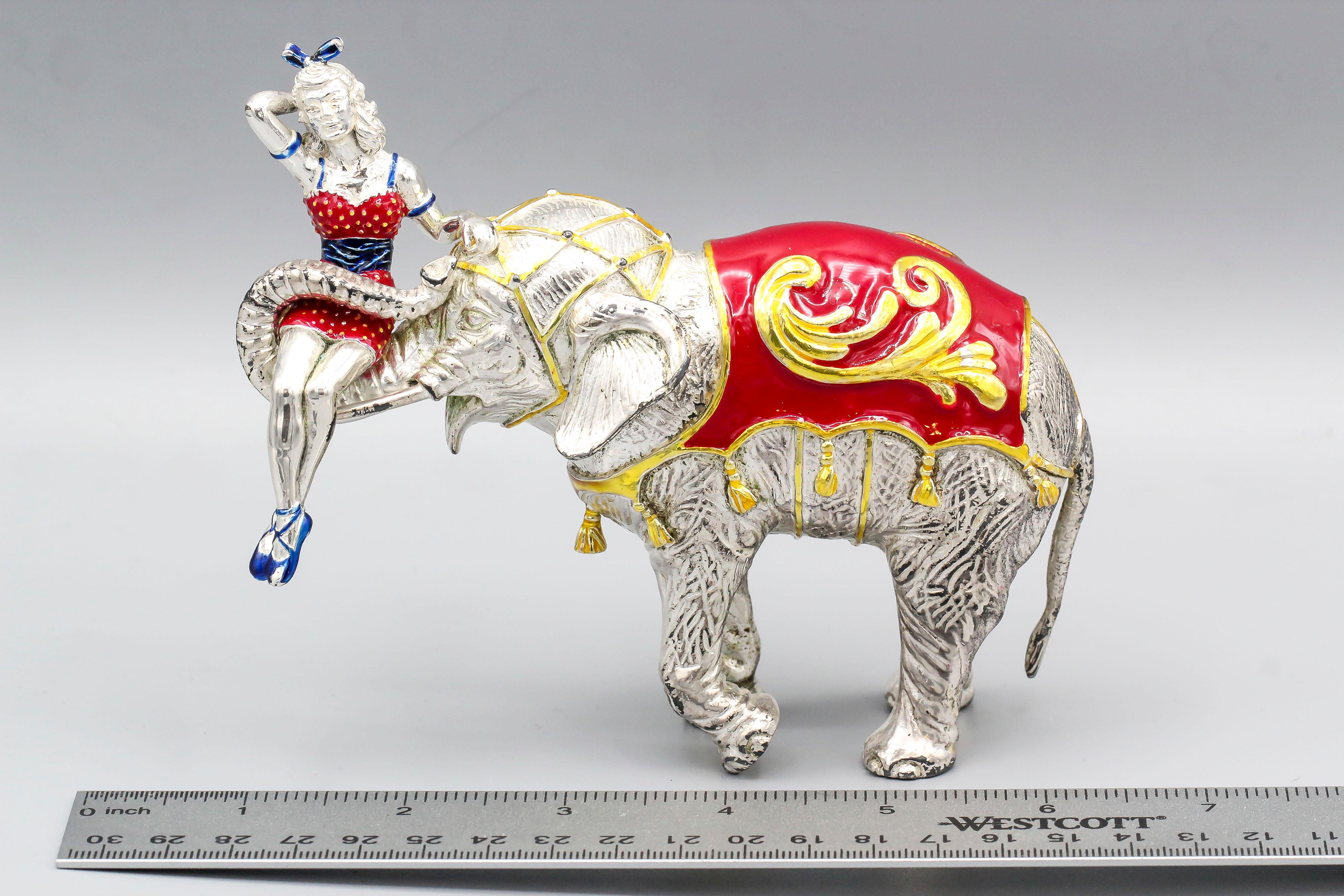 Rare and unusual sterling silver and multi colored enamel circus figurine by Tiffany & Co., circa 1990s. It features an elephant with a showgirl sitting on its trunk.  This is a rarer figurine in that it is larger and heavier than other elephant