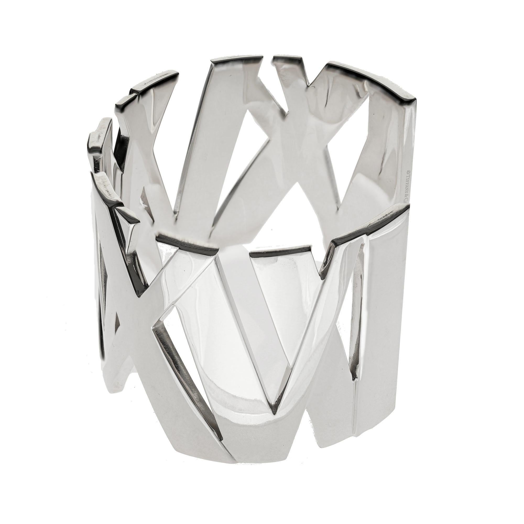 Tiffany & Co Wide sterling silver Atlas cuff bracelet with Roman numerals. 

Sterling Silver 
Stamped: 925
Hallmark: T + Co
123 grams
Width: 1 5/8 

