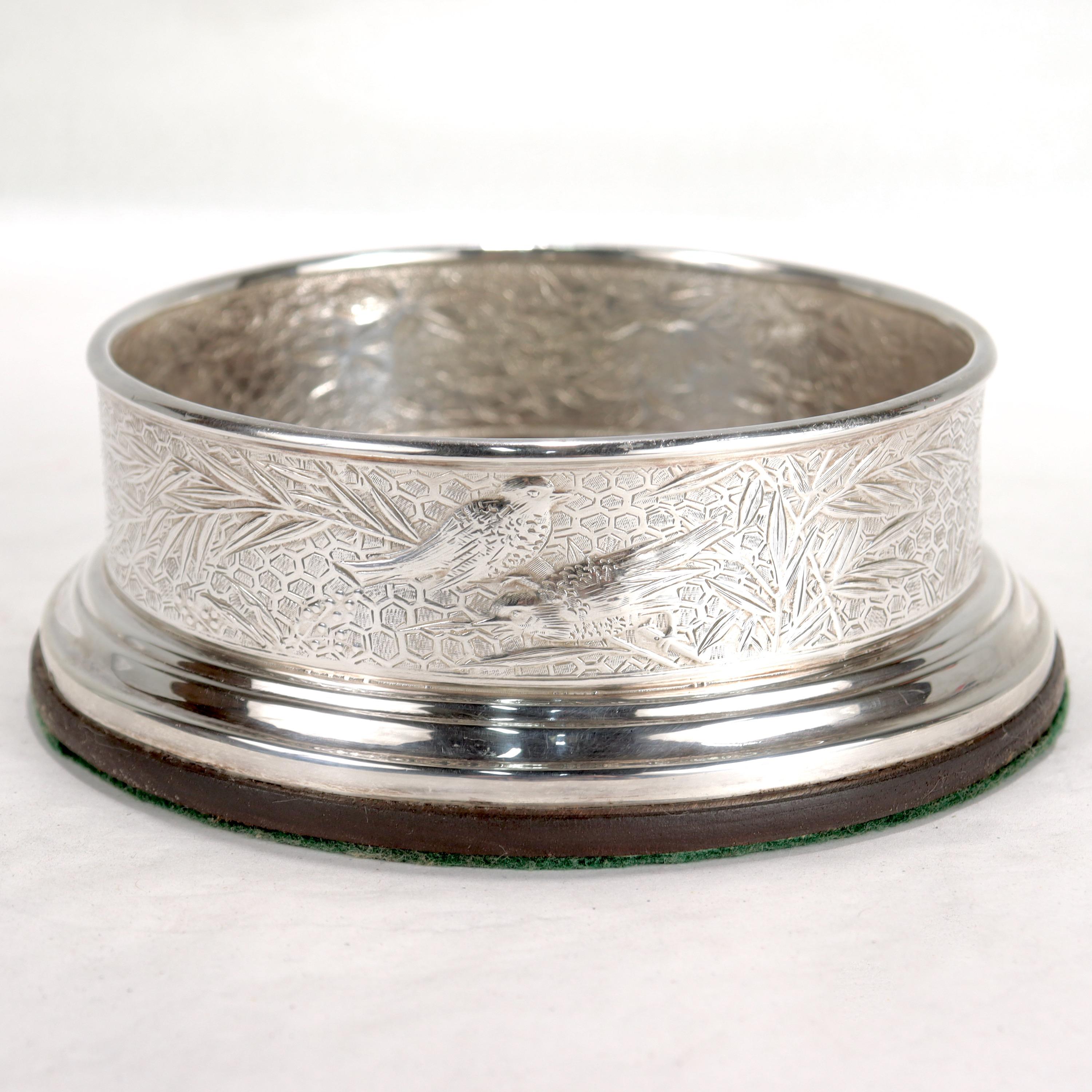 A very fine sterling silver wine coaster.

By Tiffany & Co.

In the Audubon pattern.

With etched floral & honeycomb decoration throughout that incorporates flowers, spiderwebs, and birds.

With a felt pad to the base. 

Marked to the side of the