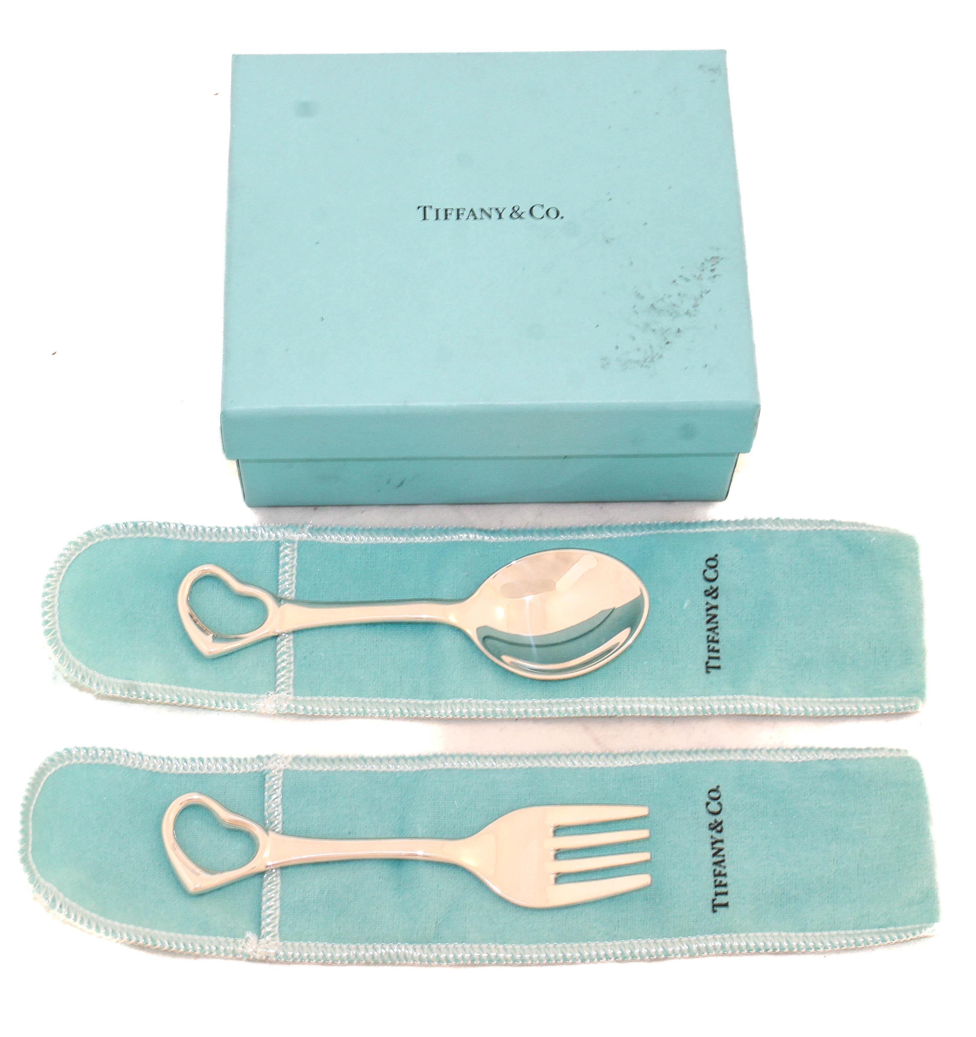 Elegant and timeless, this classic Tiffany & Co. baby flatware set includes an open heart sterling silver fork and spoon, perfectly sized for little hands. Crafted with Tiffany’s renowned attention to detail, the pieces feature a sleek, contemporary