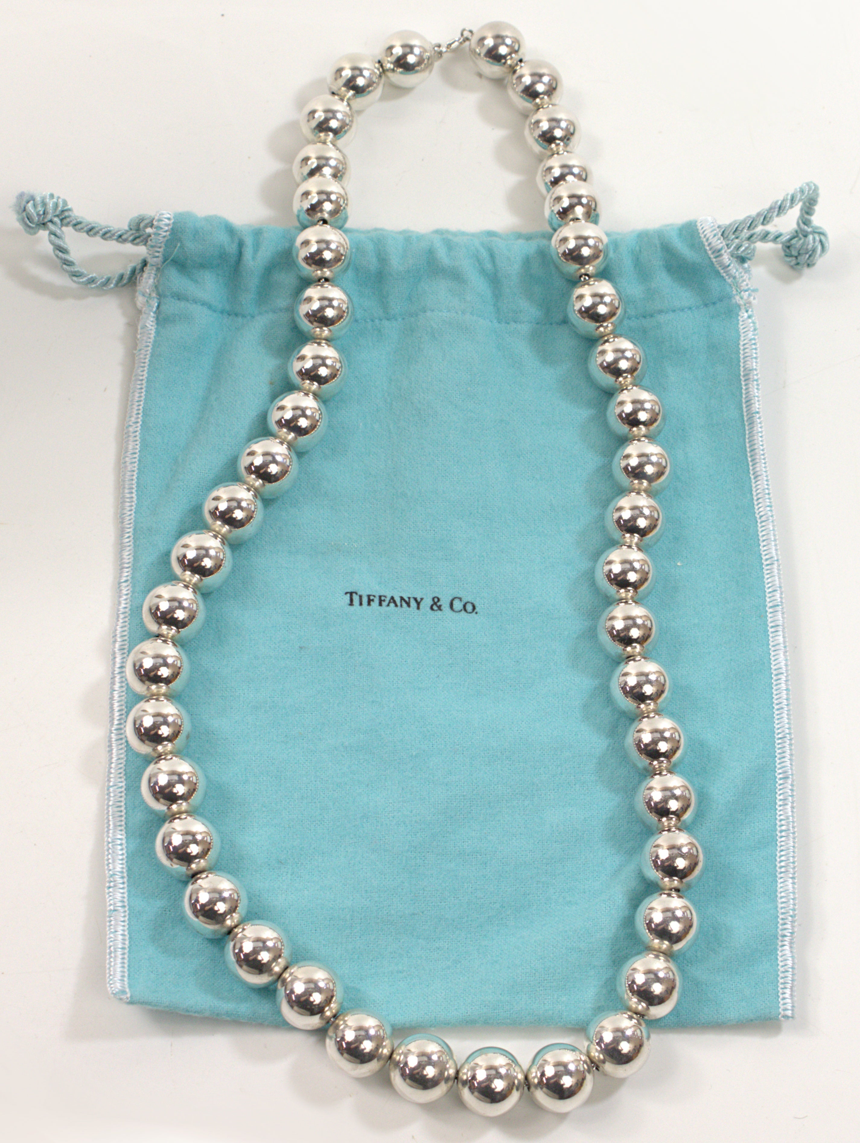 Composed of (44) sterling silver ball beads, 16 mm, strung on a sterling link chain, completed by a lobster claw clasp and Tiffany & Co tag, marked 925, © Tiffany & Co, forming a 28-inch necklace, Total weight 145.76 grams, accompanied by Tiffany &