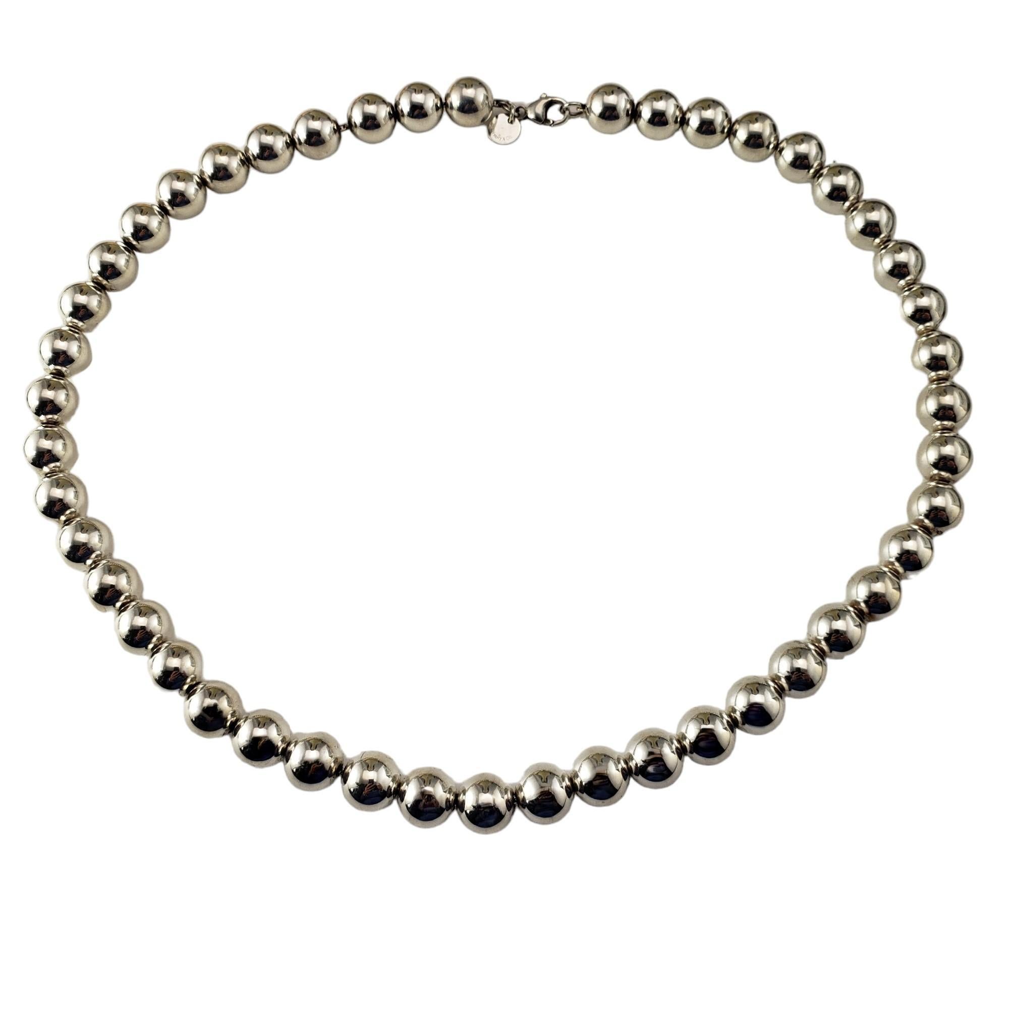 Tiffany & Co. Sterling Silver Ball Necklace-

This lovely ball necklace is crafted in elegant sterling silver by Tiffany & Co.  

Width: 10 mm.

Matching bracelet: #17162
Matching earrings: #17163

Size: 18 inches

Hallmark:  TIFFANY & CO.