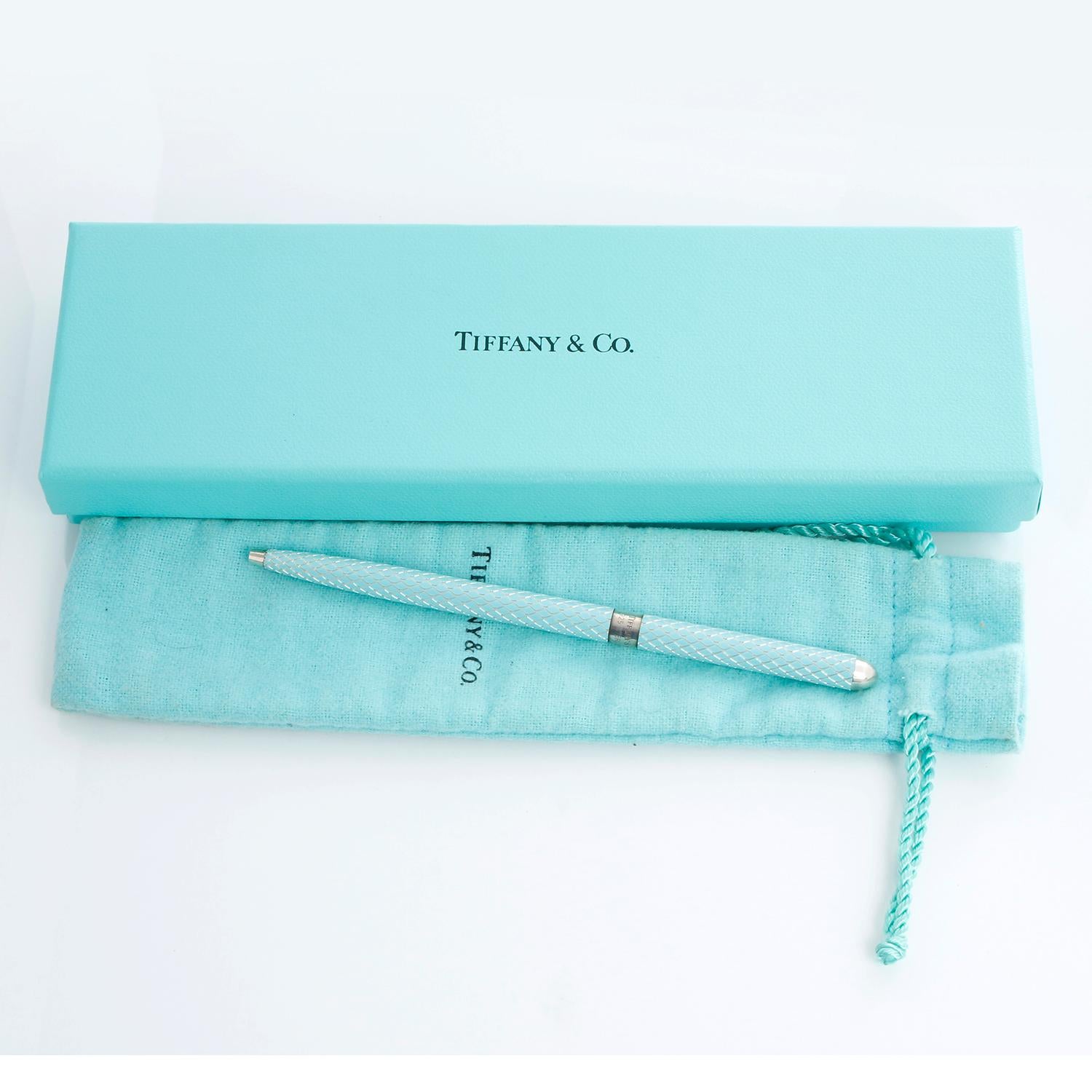 Tiffany & Co. Sterling Silver Ballpoint Purse Pen  - Sterling silver and Tiffany blue enamel Tiffany & Co. ballpoint purse pen with twist retractable closure, diamond pattern at enamel finish and brand stamp and hallmark at center band. Includes box