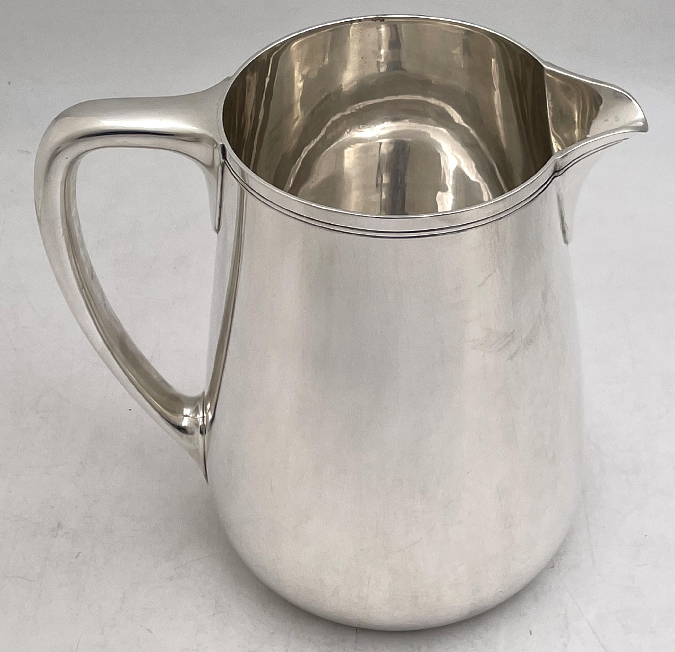 Tiffany & Co. sterling silver bar pitcher in Mid-Century Modern style, with an elegant, geometric design, made in the late 1940s or early 1950s. It measures 6 2/3'' in height by 6 3/4'' from handle to spout, weighs 21 troy ounces, and bears