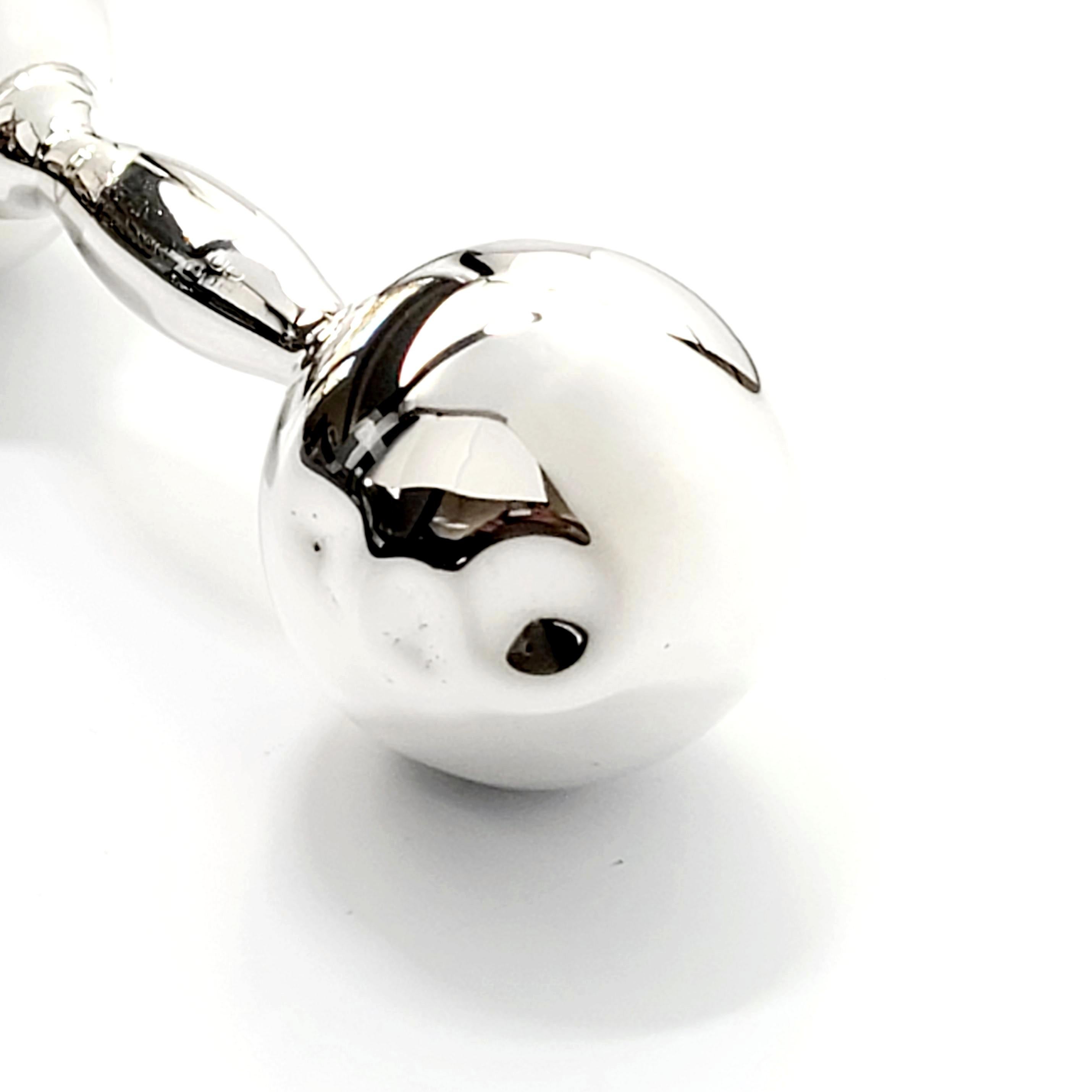 Tiffany & Co sterling silver barbell rattle.

This is a beautiful and charming sterling silver dumbbell baby rattle, a classic design by Tiffany & Co. It has a soft sweet jingle when you shake it.

Measures approx 4 1/2