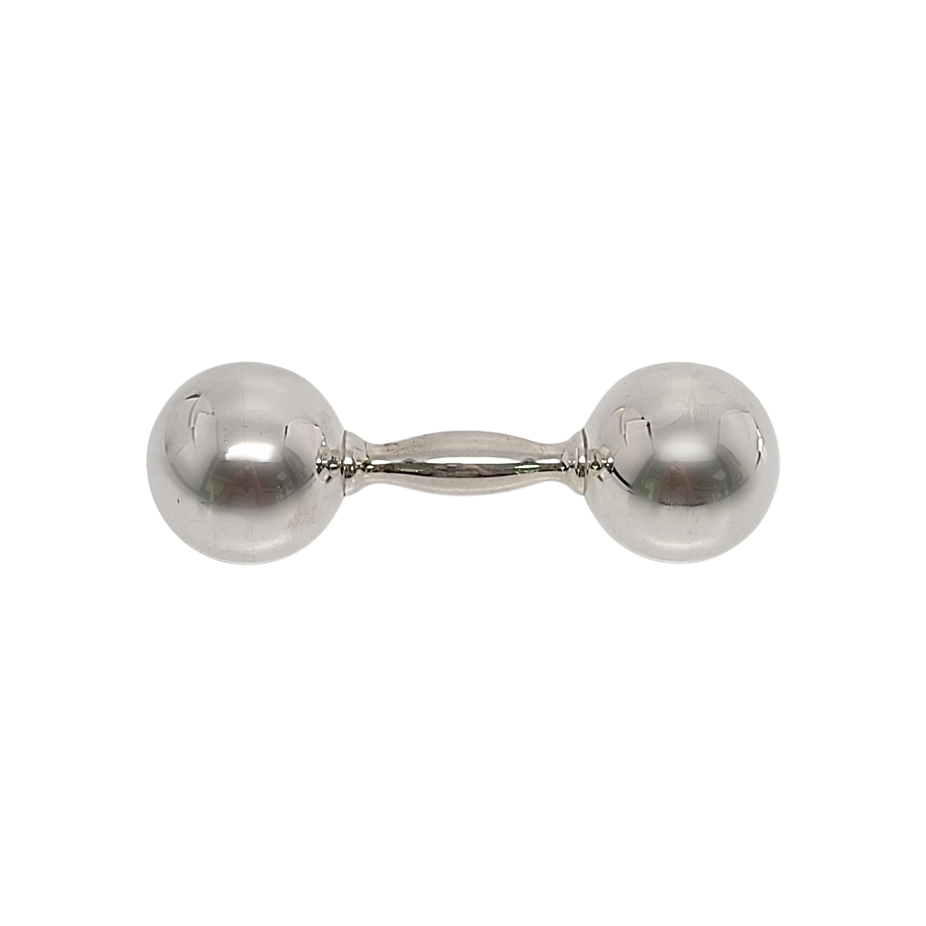 Tiffany & Co sterling silver barbell rattle.

This is a beautiful and charming sterling silver dumbbell baby rattle, a classic design by Tiffany & Co. It has a soft sweet jingle when you shake it. Does not include Tiffany & Co box or