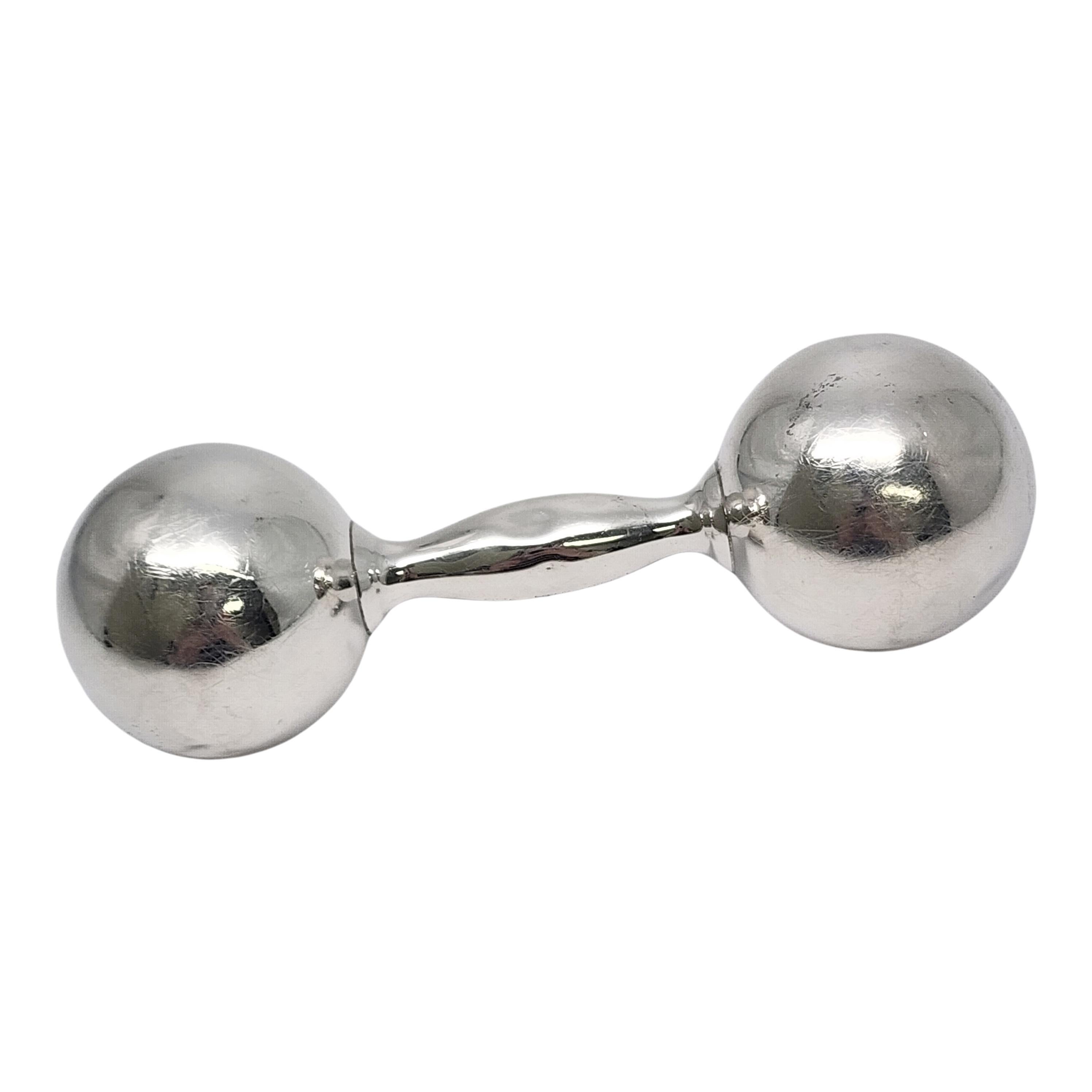 Tiffany & Co sterling silver barbell rattle with monogram.

Monogram appears to be CBK (see photos)

This is a beautiful and charming authentic sterling silver dumbbell baby rattle designed by Tiffany & Co. It has a soft sweet jingle when you shake