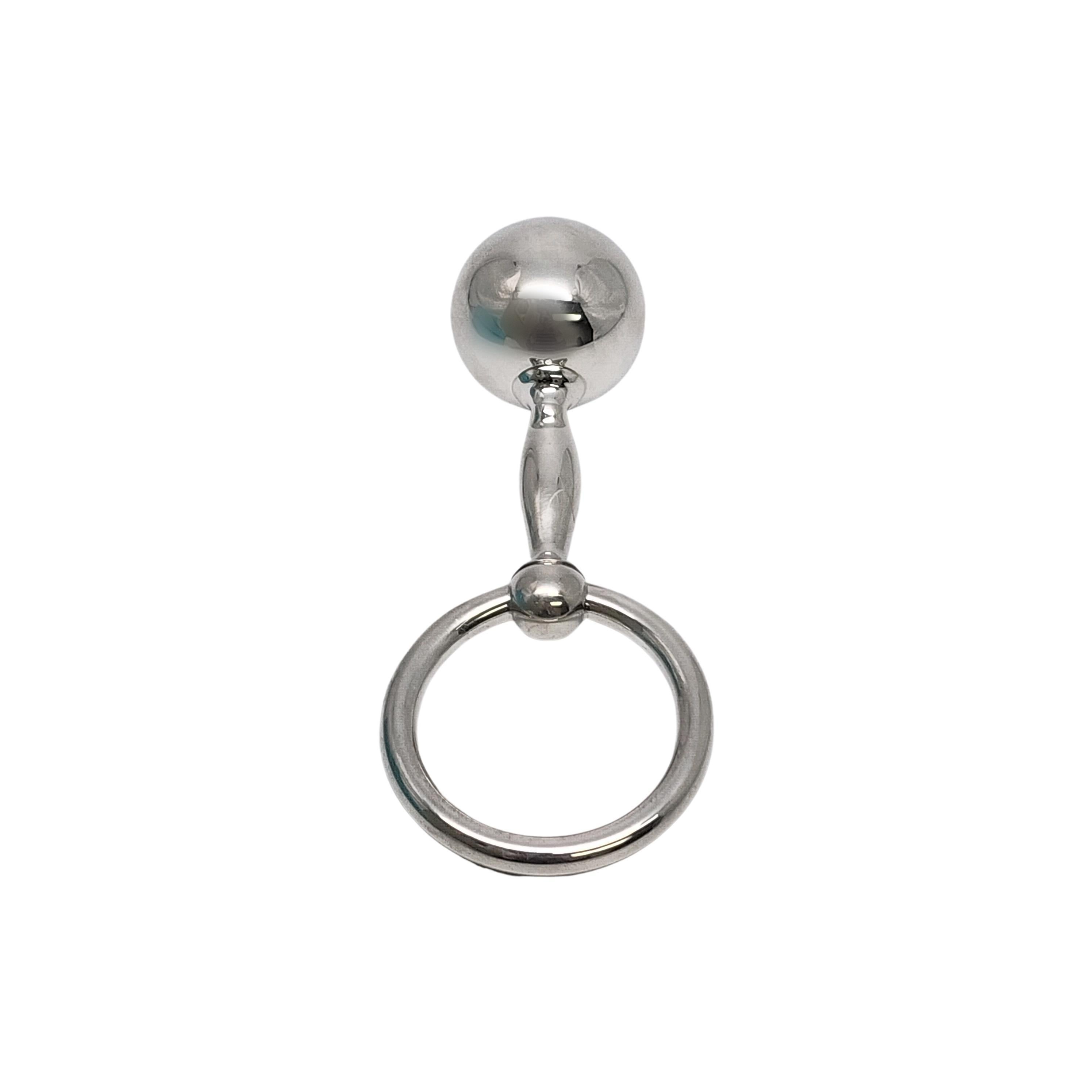Tiffany & Co sterling silver barbell teething ring rattle with Tiffany box and pouch.

This is a beautiful and charming authentic sterling silver baby rattle designed by Tiffany & Co featuring a barbell on one side and a teething ring on the other