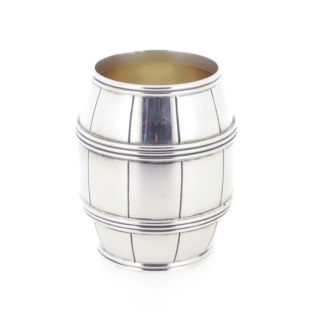 A silver barrel-shaped bar accessoriy.

By Tiffany & Co.

In sterling silver.

In a barrel form with a gold washed interior. 

Marked to the base for Tiffany & Co. / Maker's / Sterling / 24058. 

Simply wonderful design by Tiffany!

Date:
20th