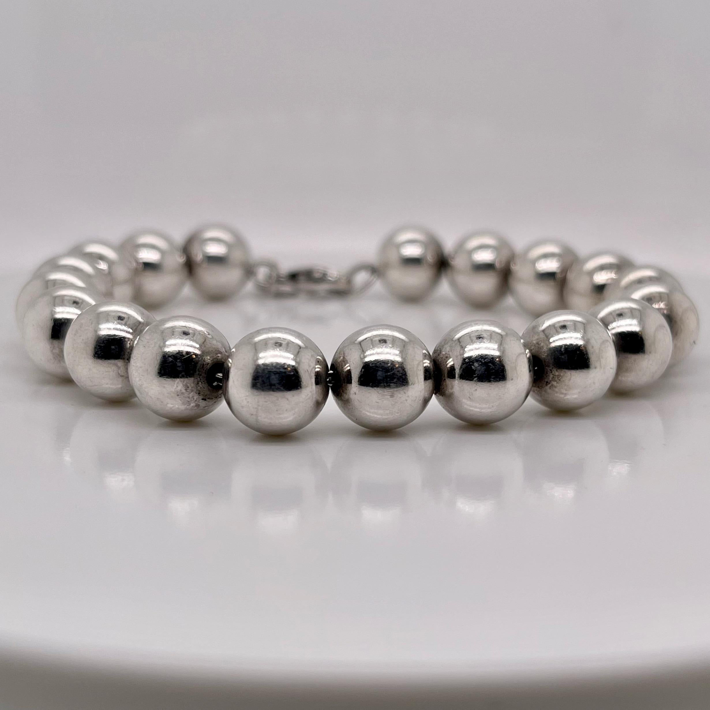 A fine Tiffany & Co. beaded bracelet.

In sterling silver with 10 mm beads and a lobster claw clasp.

Marked for Tiffany & Co and 925 for sterling silver fineness.

A wonderful bracelet and great Tiffany design!

Date:
20th Century

Overall