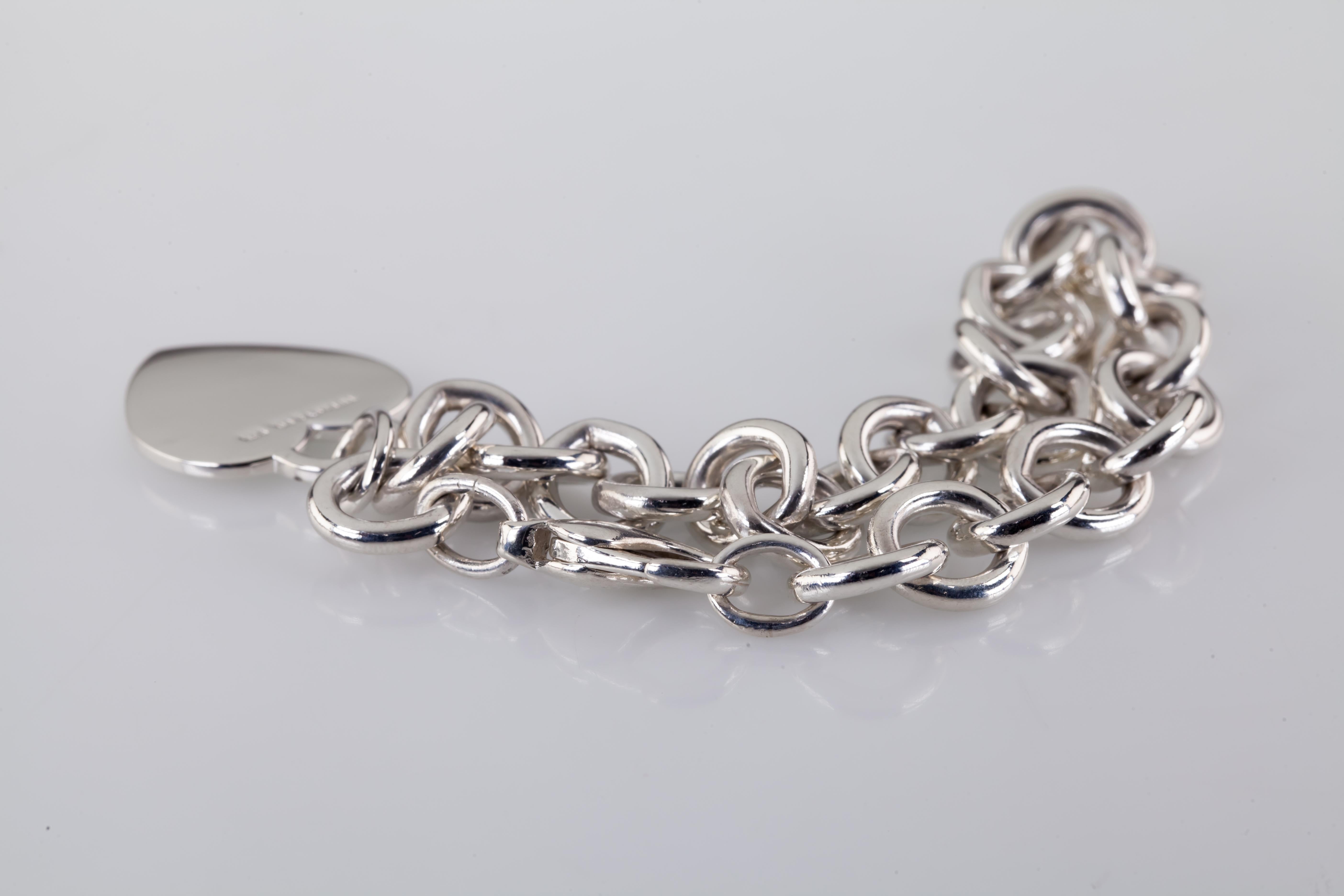Beautiful sterling silver blank heart tag charm bracelet
Guaranteed authentic Tiffany sterling silver
7.75 inches long
37.0 grams
Retails for $375 in the Tiffany Store
