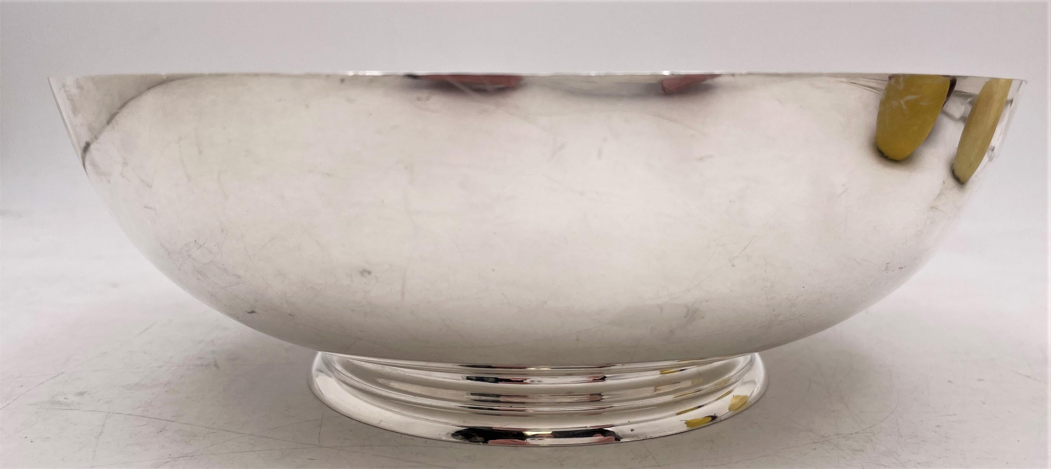 Tiffany & Co., sterling silver bowl in pattern number 24023 from the 1950s or 1960s in Mid-Century Modern style with a beautiful geometric design, standing on a base, measuring 8 3/4'' in diameter by 3'' in height, weighing 22 troy ounces, and