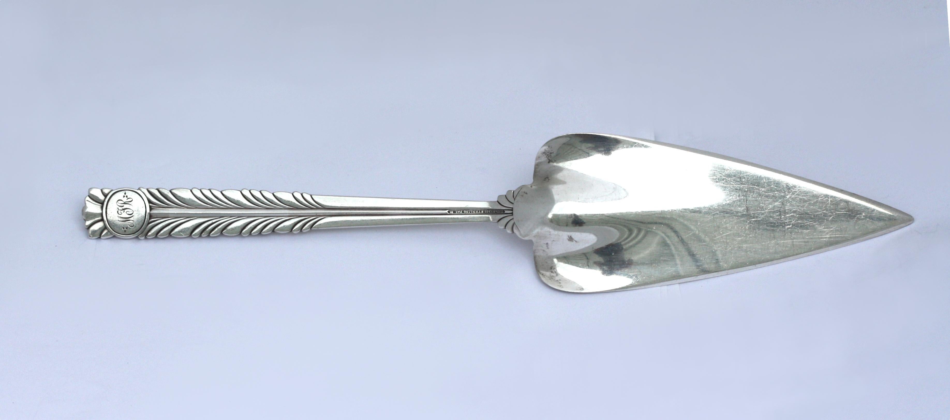 
Tiffany & Co. Sterling Silver Cake Server
Marked, Tiffany & Co, Sterling. In the Tomato / Exhibition pattern.
The handle cast with graduating stylized circular and bead motifs.
Length 11.75 in. (29.84 cm.), 5.3 ozt.