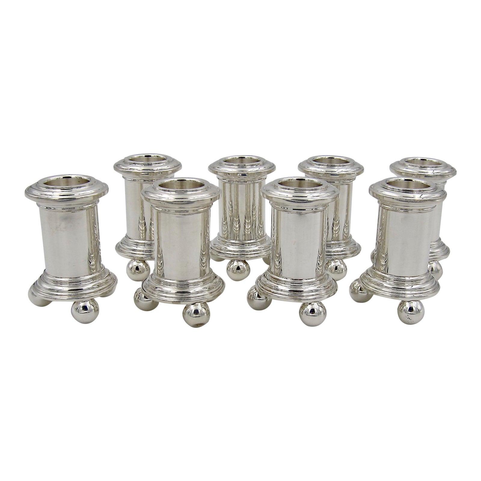 A set of eight sterling silver. Candleholders from Tiffany & Co. The vintage silver candlesticks hold standard size taper candles, the form resembles a column resting on a spreading stepped base supported by three ball feet.

The candleholders are