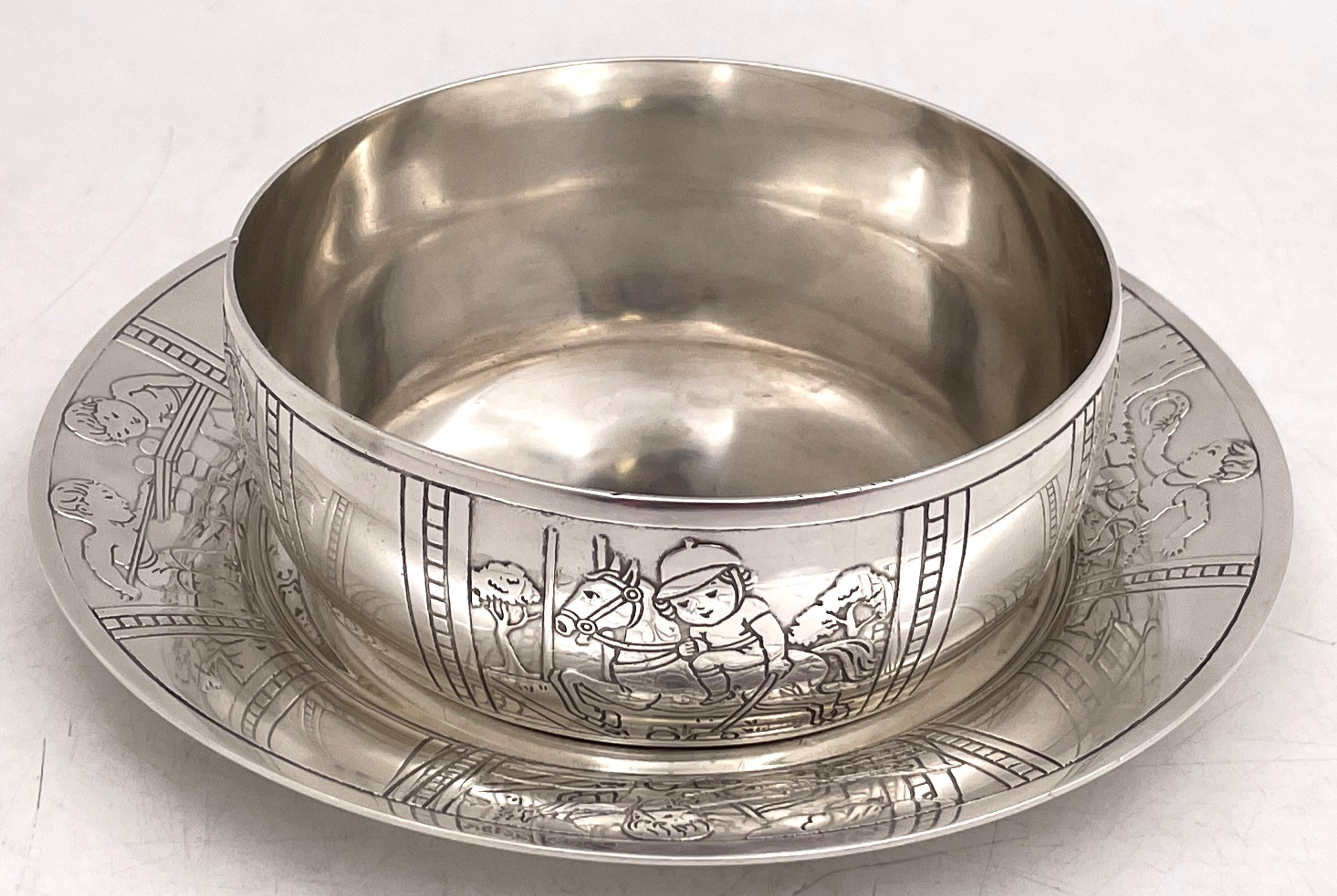 Tiffany & Co. sterling silver child bowl and underplate, showcasing boys playing various sports, and in Art Deco style, with an elegant geometric design. The design is from 1927 (pattern number 20850B) but the set was made between 1943 and 1945. The