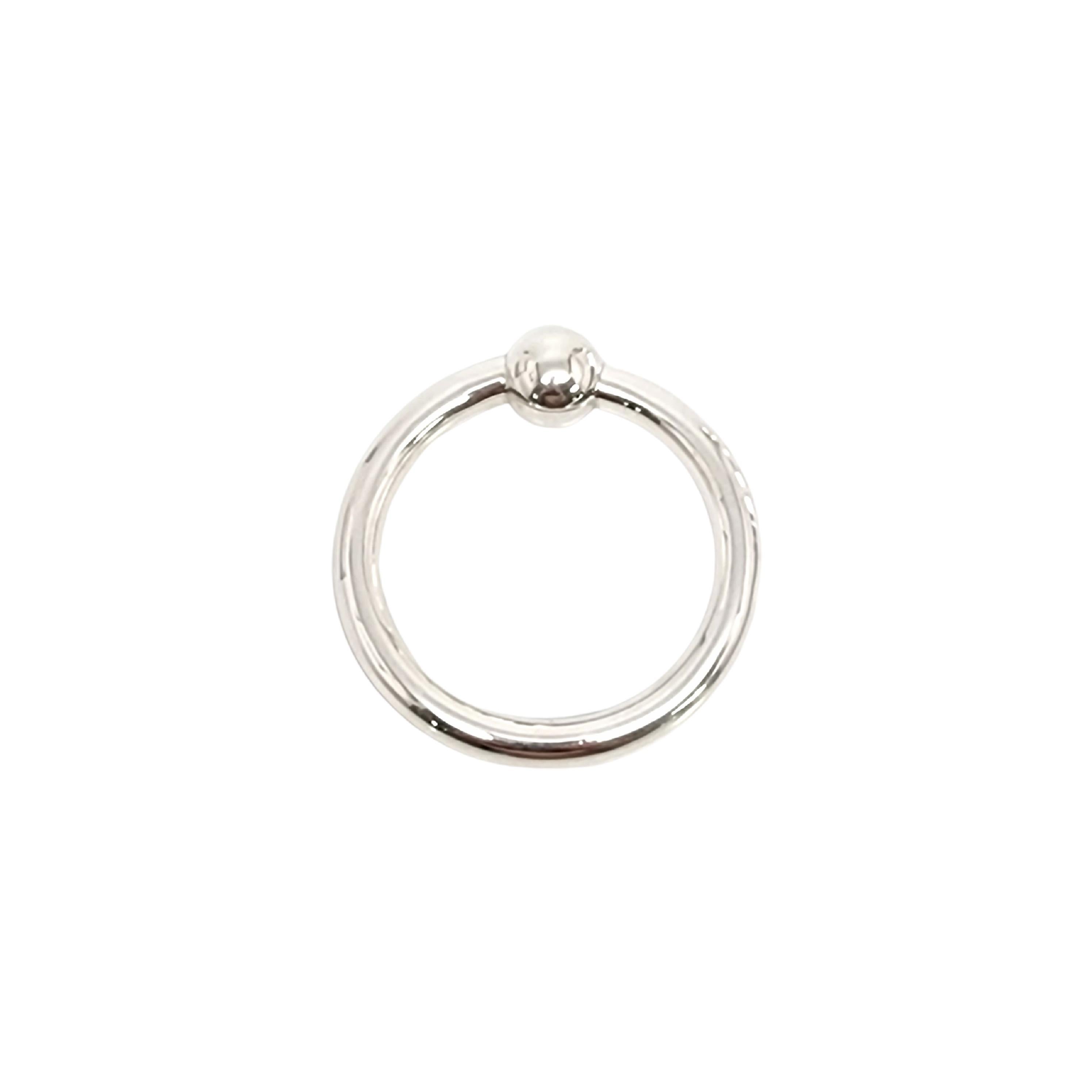 Tiffany & Co sterling silver circle ring rattle with pouch.

This is a beautiful and charming sterling silver circle ring baby rattle with a ball, a classic design by Tiffany & Co. It has a soft sweet jingle when you shake it. Includes Tiffany