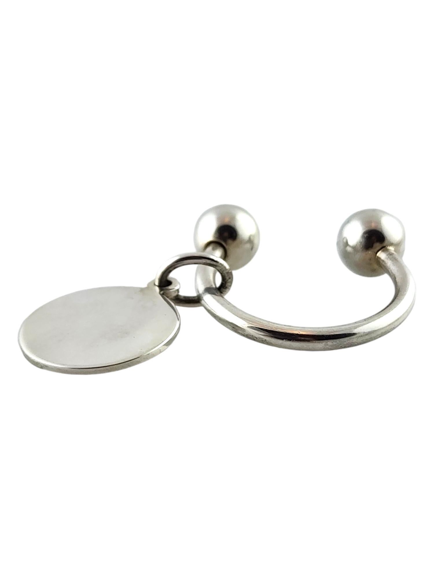 Tiffany & Co Sterling Silver Circle Tag Key Ring

This beautiful Tiffany & Co. sterling silver key ring is paired with their classic circle charm!

Key ring: 30.3mm X 9.2mm X 9.37mm
Tag: 23.17mm X 19.03mm X 1.26mm

Weight: 10.32 g/ 6.64