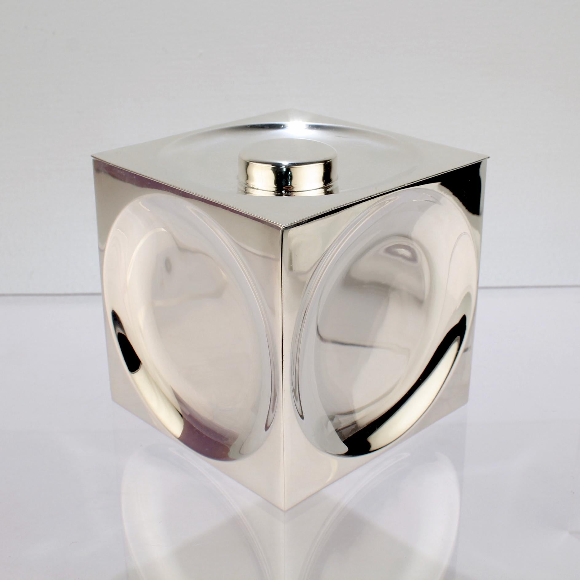 A wonderful vintage Modernist, geometric Tiffany & Co. box in sterling silver.

In the form of a cube with convex or inverted circles to each square shaped side and the square cover. The cover has a button finial.

Simply cool, modernist Op-Art