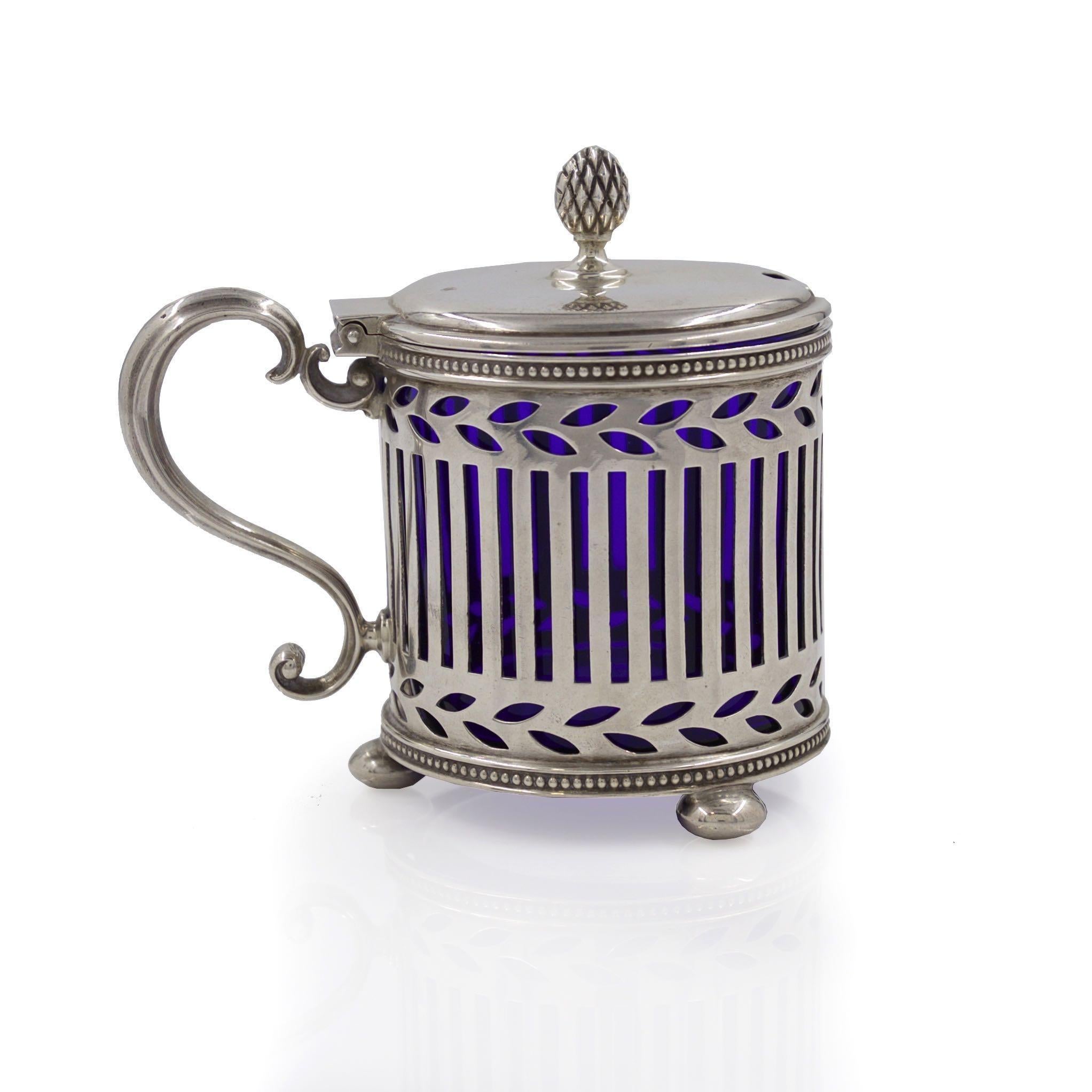 A gorgeous early 20th century mustard pot by Tiffany & Co, it retains the original removable cobalt-blue glass insert and remains in pristine original condition without any added monograms or any surface alterations. It features a nicely cast