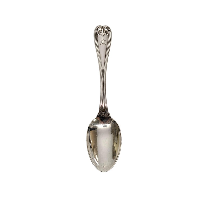 Sterling silver teaspoon by Tiffany & Co in the Colonial pattern with Tiffany & Co pouch.

Monogram appears to be McK

The Colonial pattern, designed by Paulding Farnham in 1895, features a simple scroll and leaf design on the handle. Manufactured