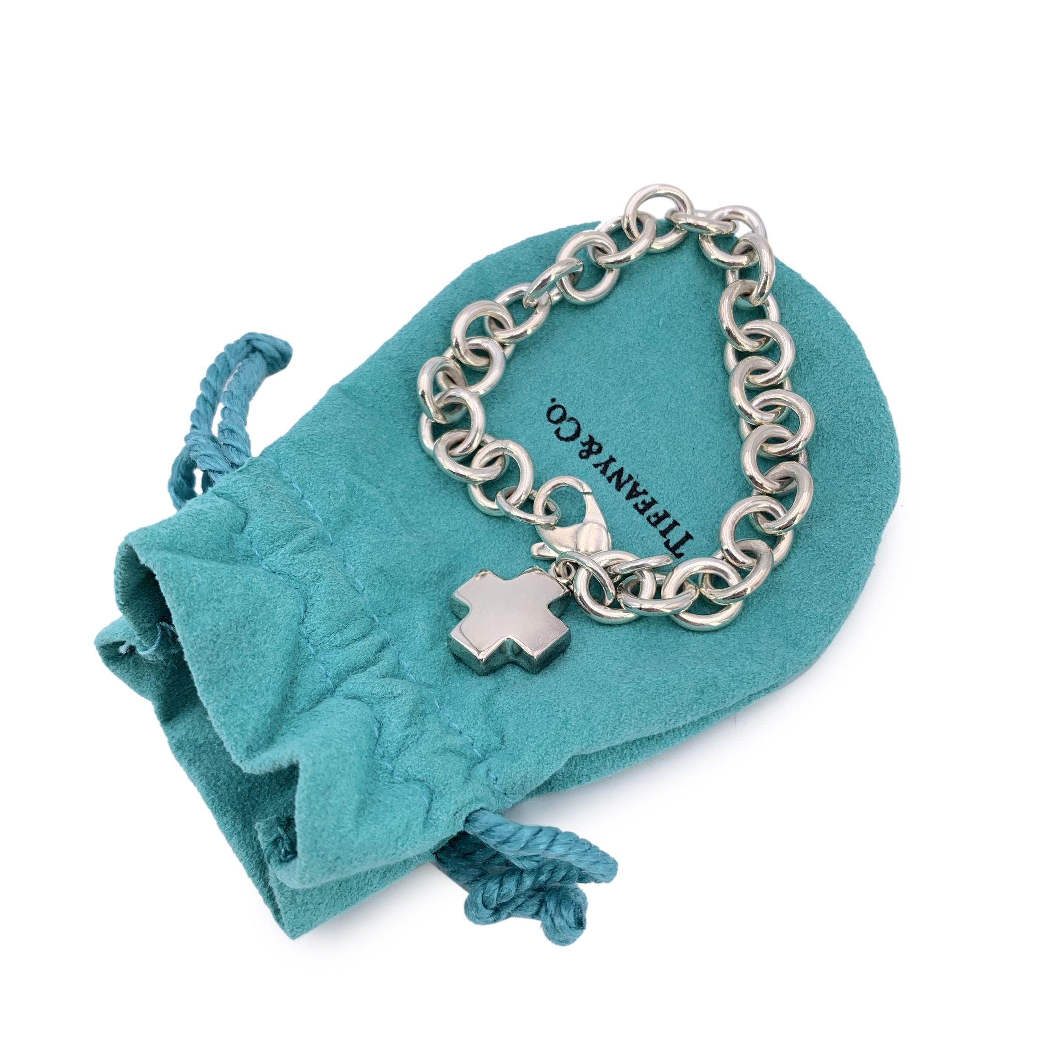This beautiful sterling silver chain bracelet by Tiffany & Co. is a perfect blend of elegance and history, featuring a cross pendant Tiffany & Co. 925. With a total length of 7.25 inches (18.3 cm), this bracelet is perfectly sized for daily wear. It
