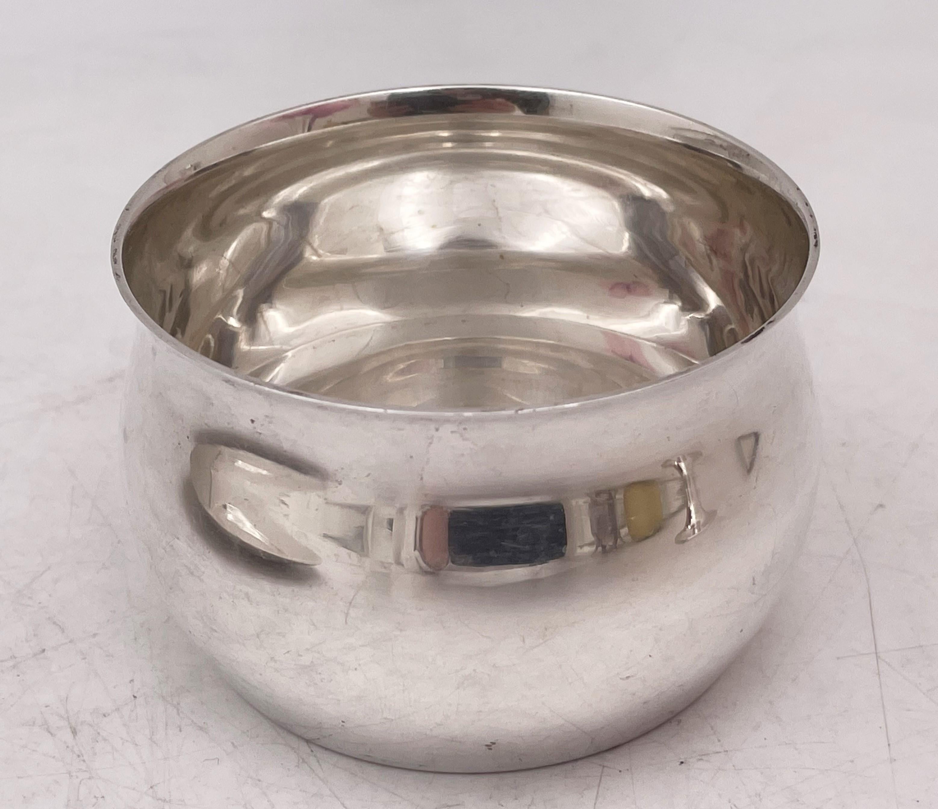 Tiffany & Co. sterling silver cup (in pattern number 23321 from 1950) and saucer (in pattern number 22739 from 19390 in Mid-Century Modern style with an elegant, geometric design. The cup measures 1 7/8'' in height 2 7/8'' in diameter at the top.