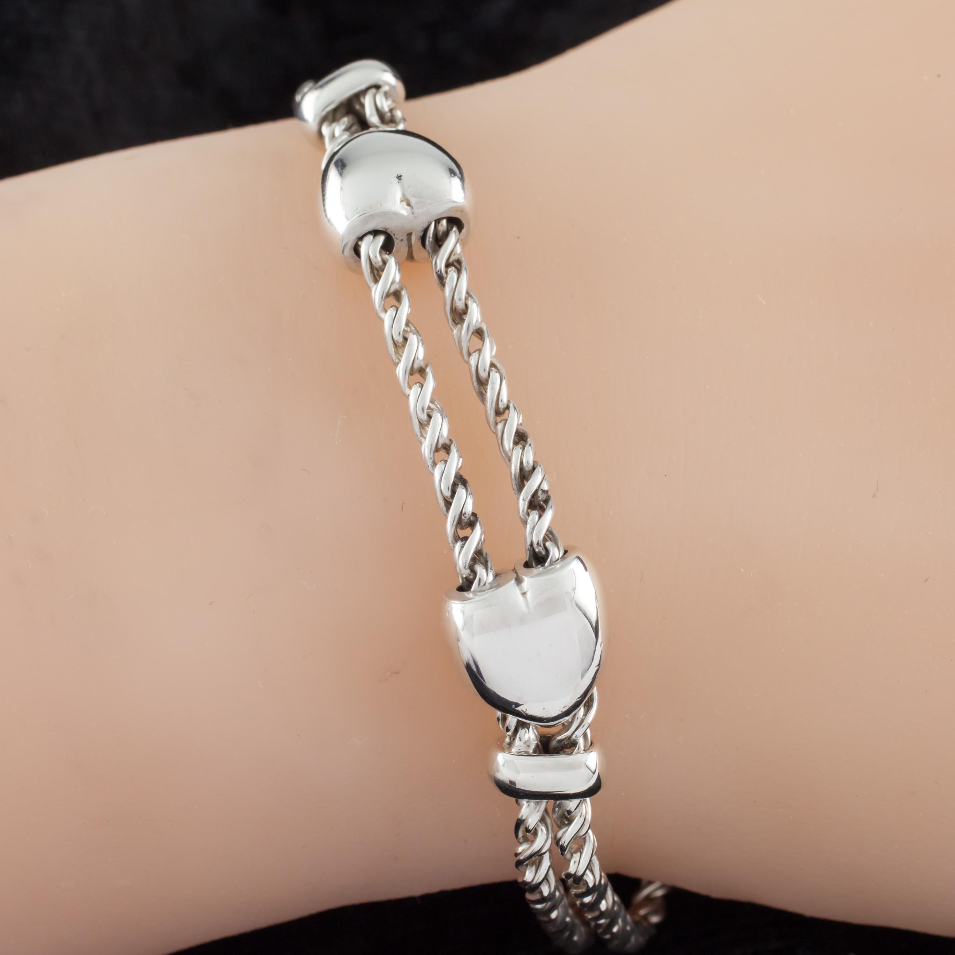 Gorgeous Bracelet by Tiffany & Co.
Features Two Hearts that Slide on Two Chains, Held Between Two Stoppers
NOTE: Very minor wire misalignment near one of the rectangular stoppers.
Total Length = 7.75