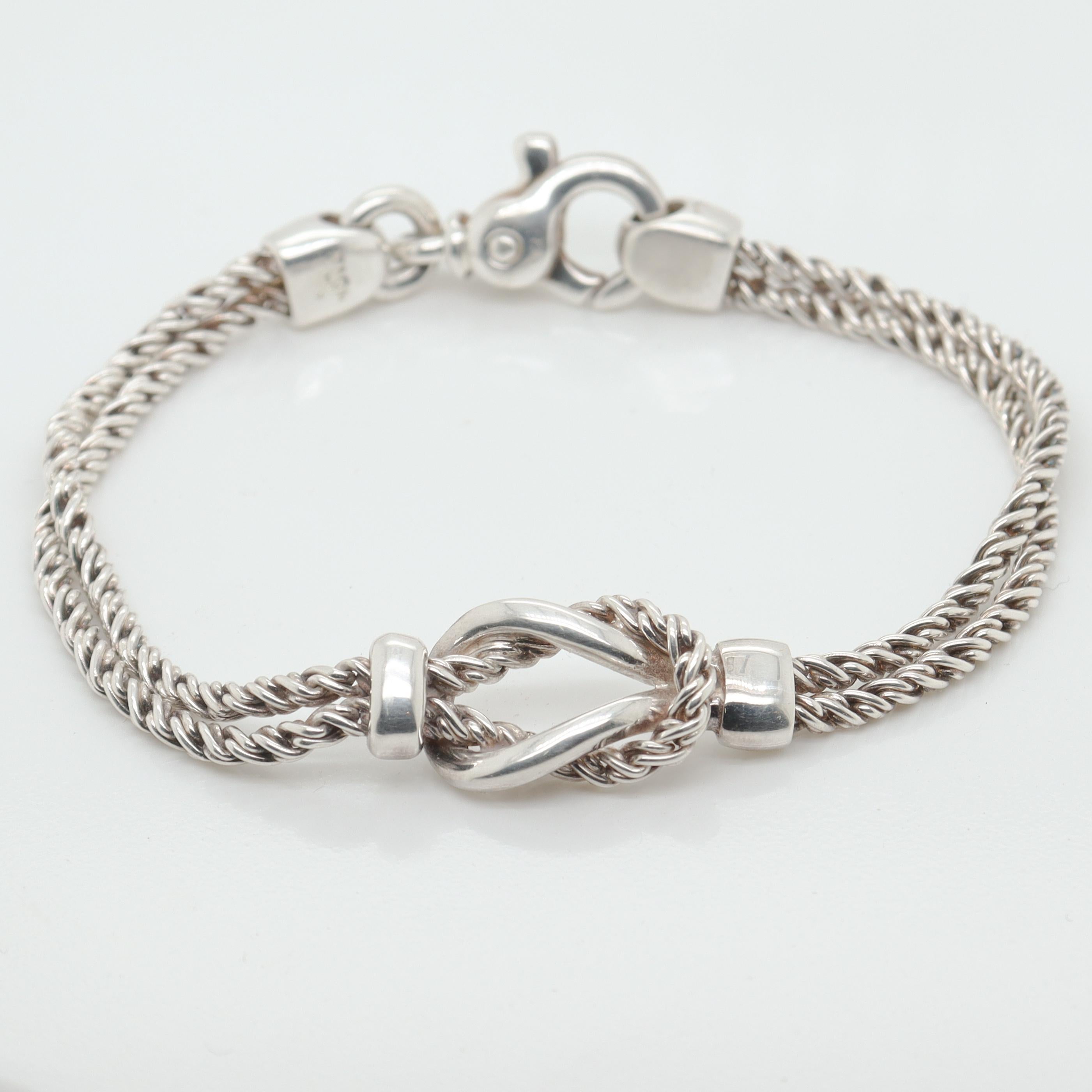 A fine love knot double rope chain bracelet.

By Tiffany & Co.

In sterling silver.

Comprised of two woven rope chains joined in a double loop love knot at the center of the bracelet.

Simply wonderful Tiffany design!

Date:
20th Century

Overall