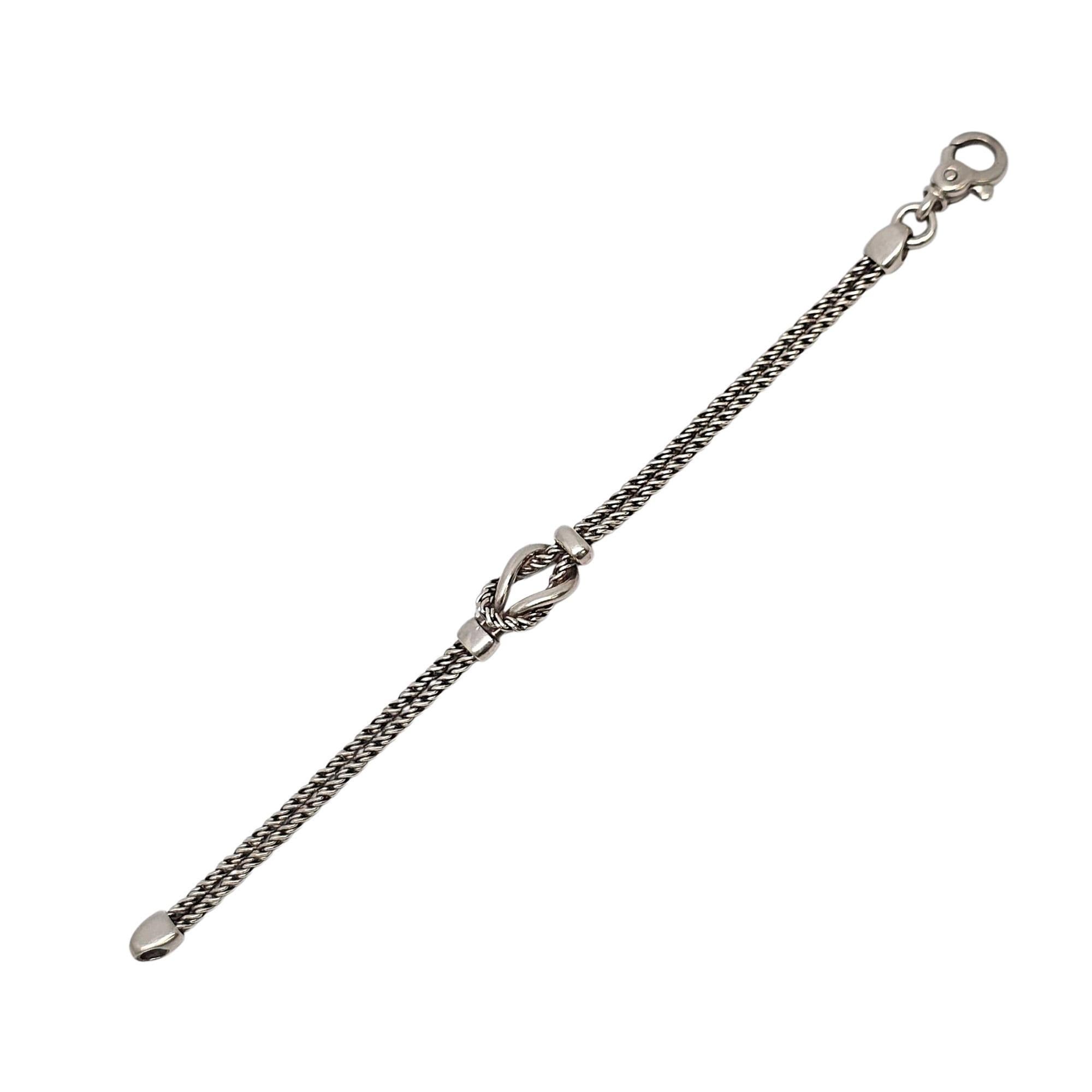 Sterling silver double rope love knot bracelet by Tiffany & Co.

This vintage Tiffany & Co bracelet features 2 twist ropes with a knot at the center featuring both a smooth polished design and the twist design knotted together. Lobster claw closure.