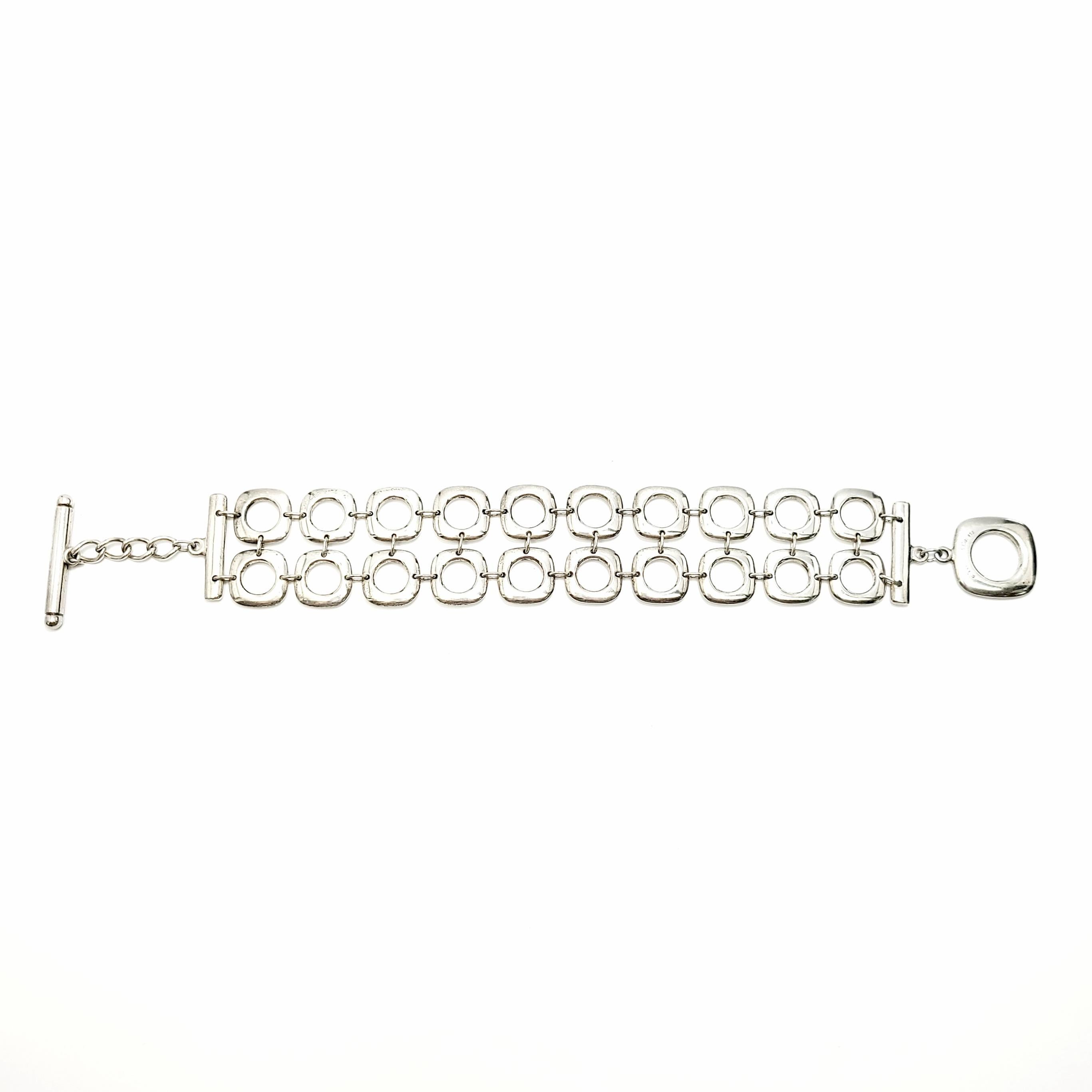 Tiffany & Co sterling silver double row square cushion link bracelet.

Authentic Tiffany bracelet featuring two rows of cushion square links with a toggle closure.

Measures approx 8 1/4