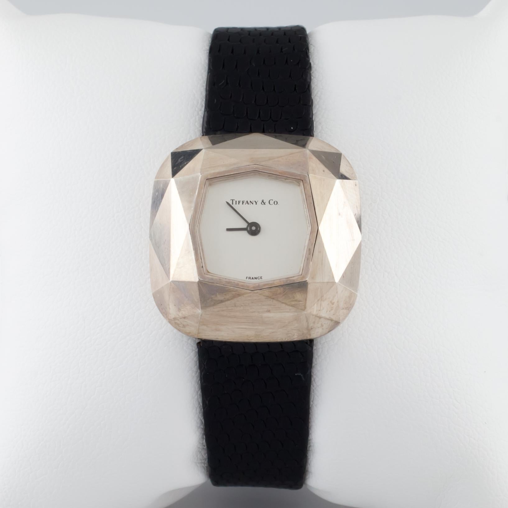 Gorgeous Watch by Tiffany & Co.
Features Sterling Silver Case Replica of Famous Tiffany Diamond
Dimensions of Case = 27 mm L x 27 mm W x 7 mm Deep
Dial = 14 mm x 14 mm
Includes Leather Band w/ Stainless Steel Clasp
Total Length = 7